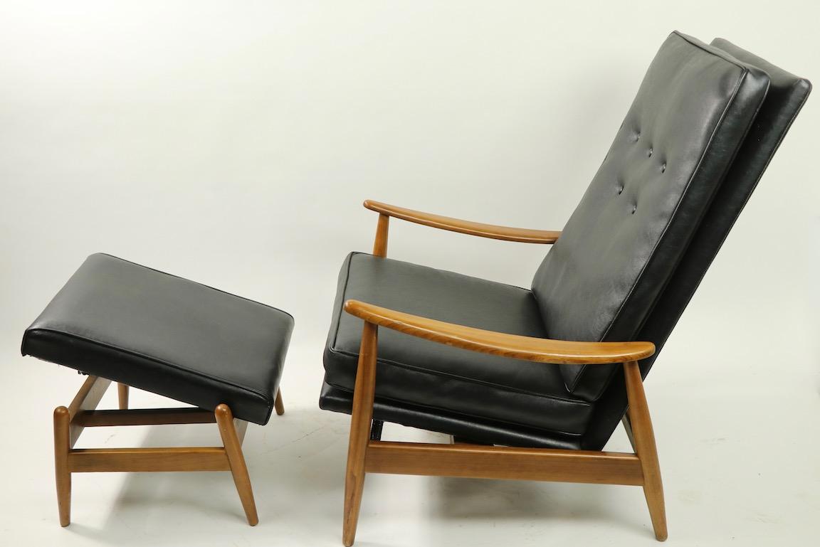 Classic midcentury reclining lounge chair and ottoman designed by Milo Baughman for the James Furniture Company. This is an early example, having the adjustable ottoman, which tilts in position. The chair is in very good original condition showing