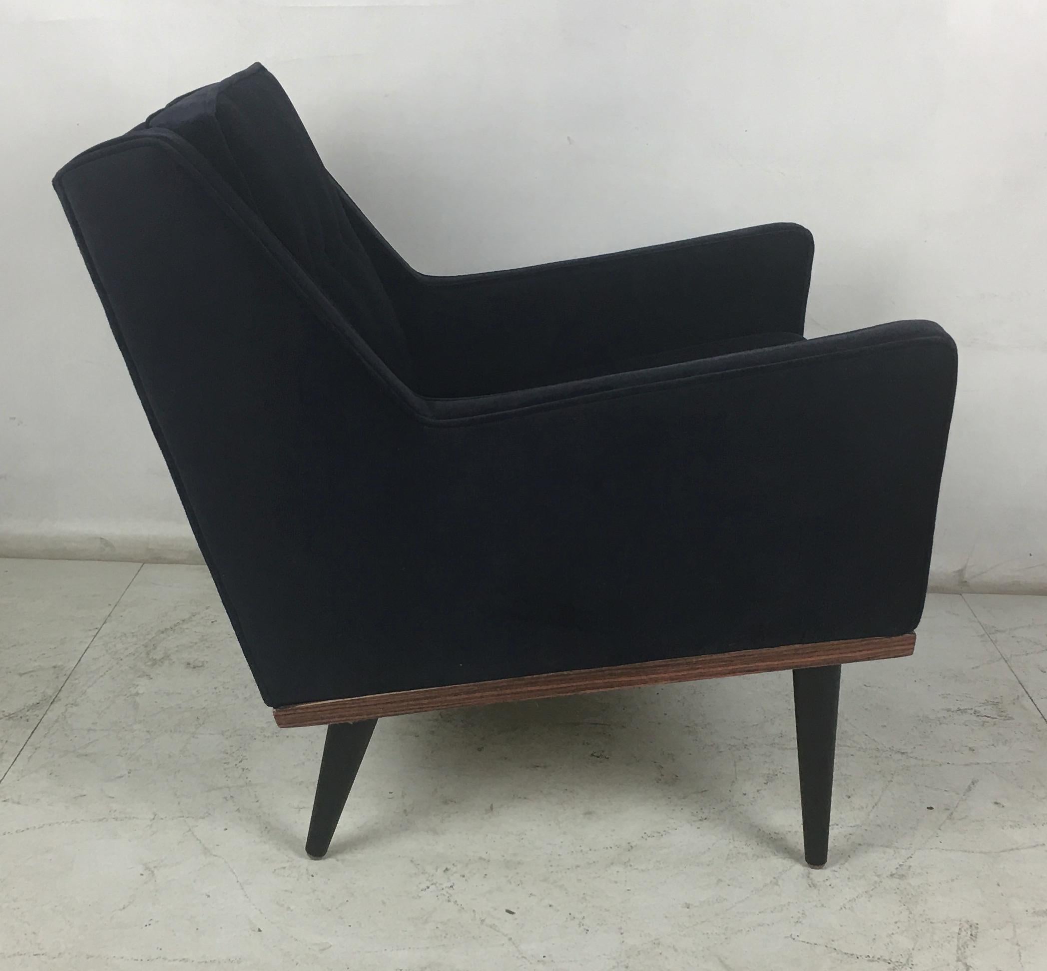 Handsome lounge chair by Milo Baughman for James, Inc. The chair has been completely restored from the ground up including new veneer on the apron, refinished legs, and has been reupholstered in luxurious heavyweight navy blue velvet. The chair is