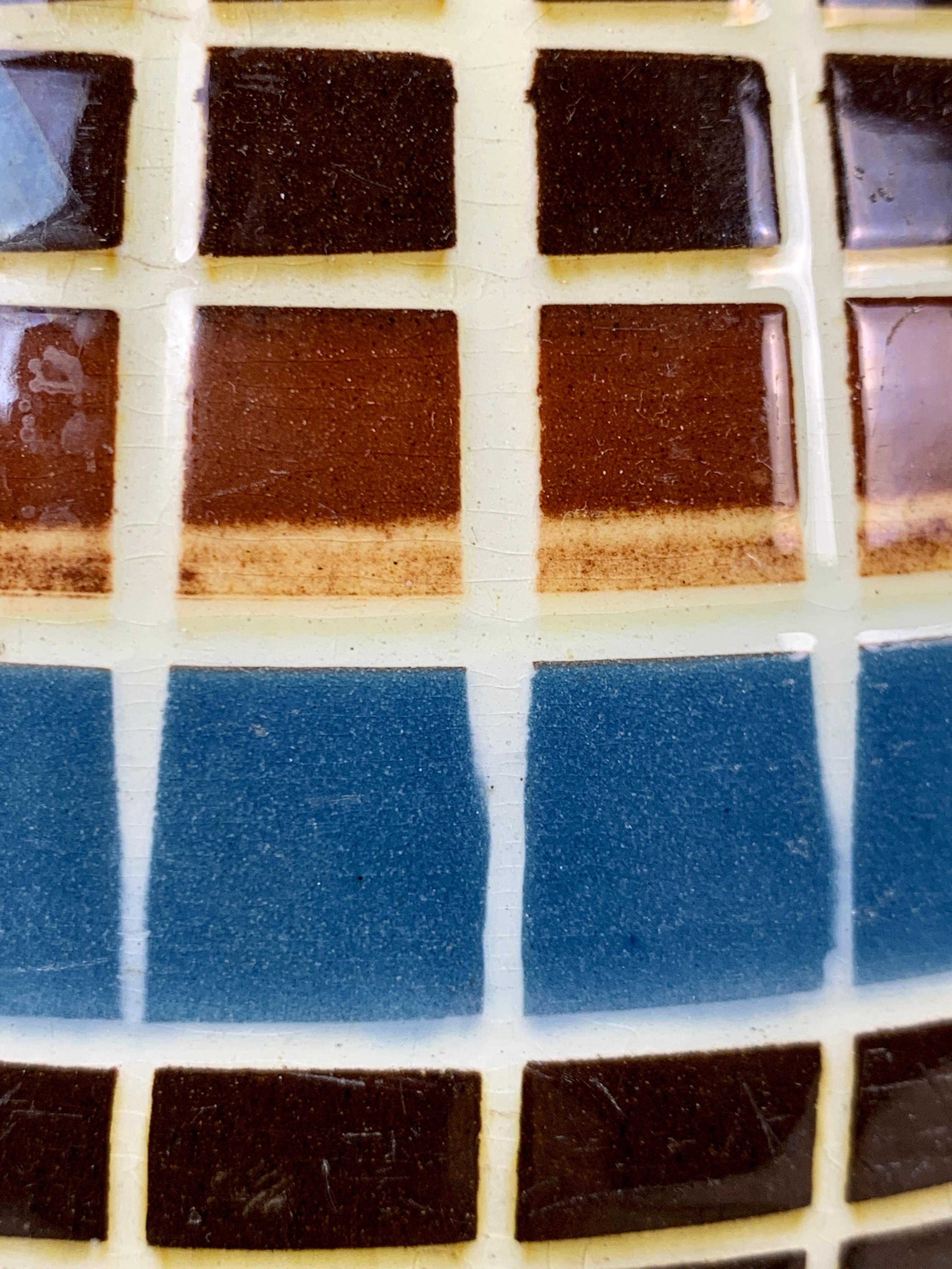 Made in England circa 1800, this large and exquisite mochaware pitcher is decorated with 16 bands of blue and brown colored slip.
Ten of these bands are cut through vertically and horizontally, forming a design of squares and rectangles.
The