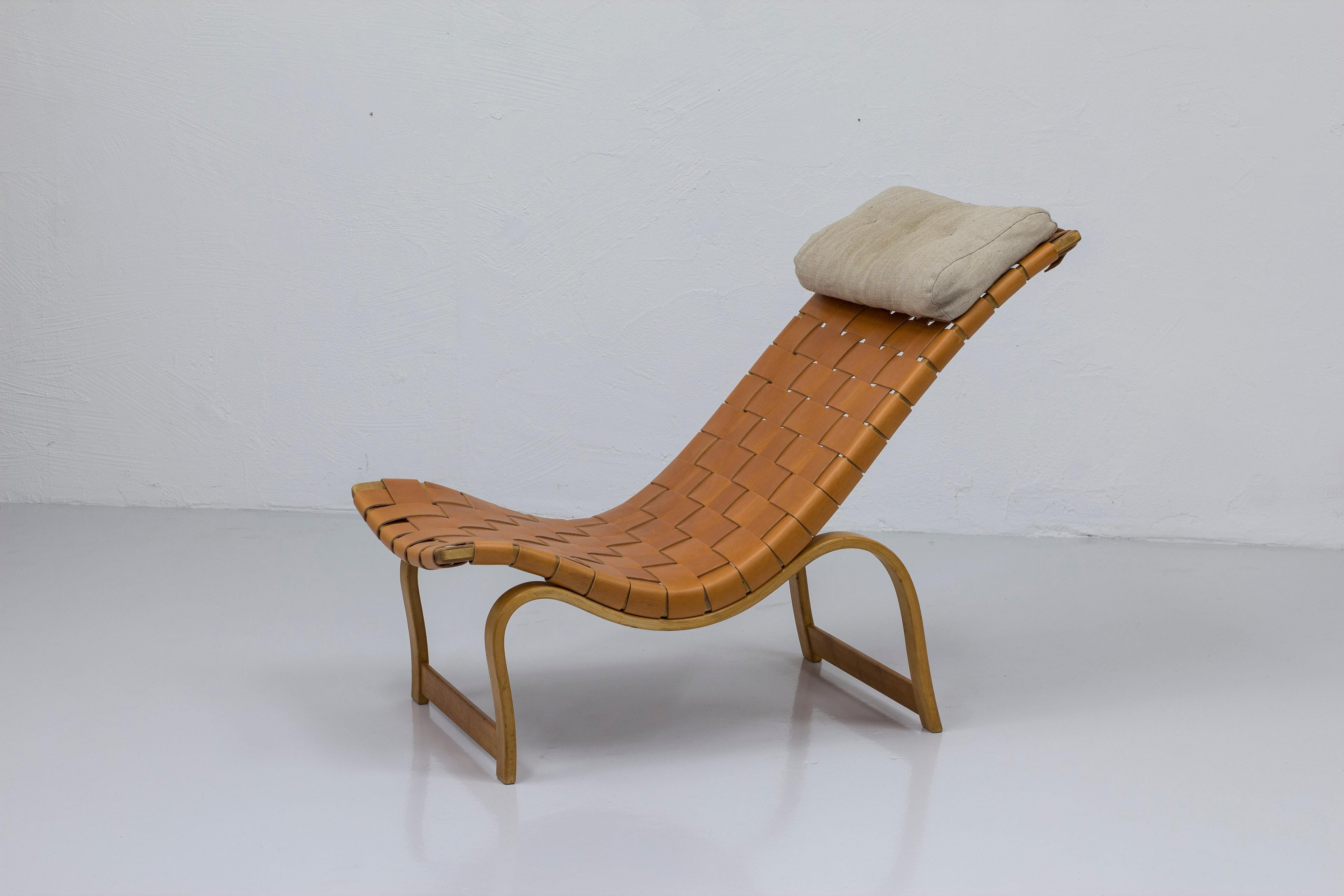 Resting chair model 36 designed by Bruno Mathsson in 1936. This example made by Firma Karl Mathsson in 1941. Made from steam bent birch and solid beech wood. New leather webbing in thick cognac hide. Very good vintage condition with age related wear
