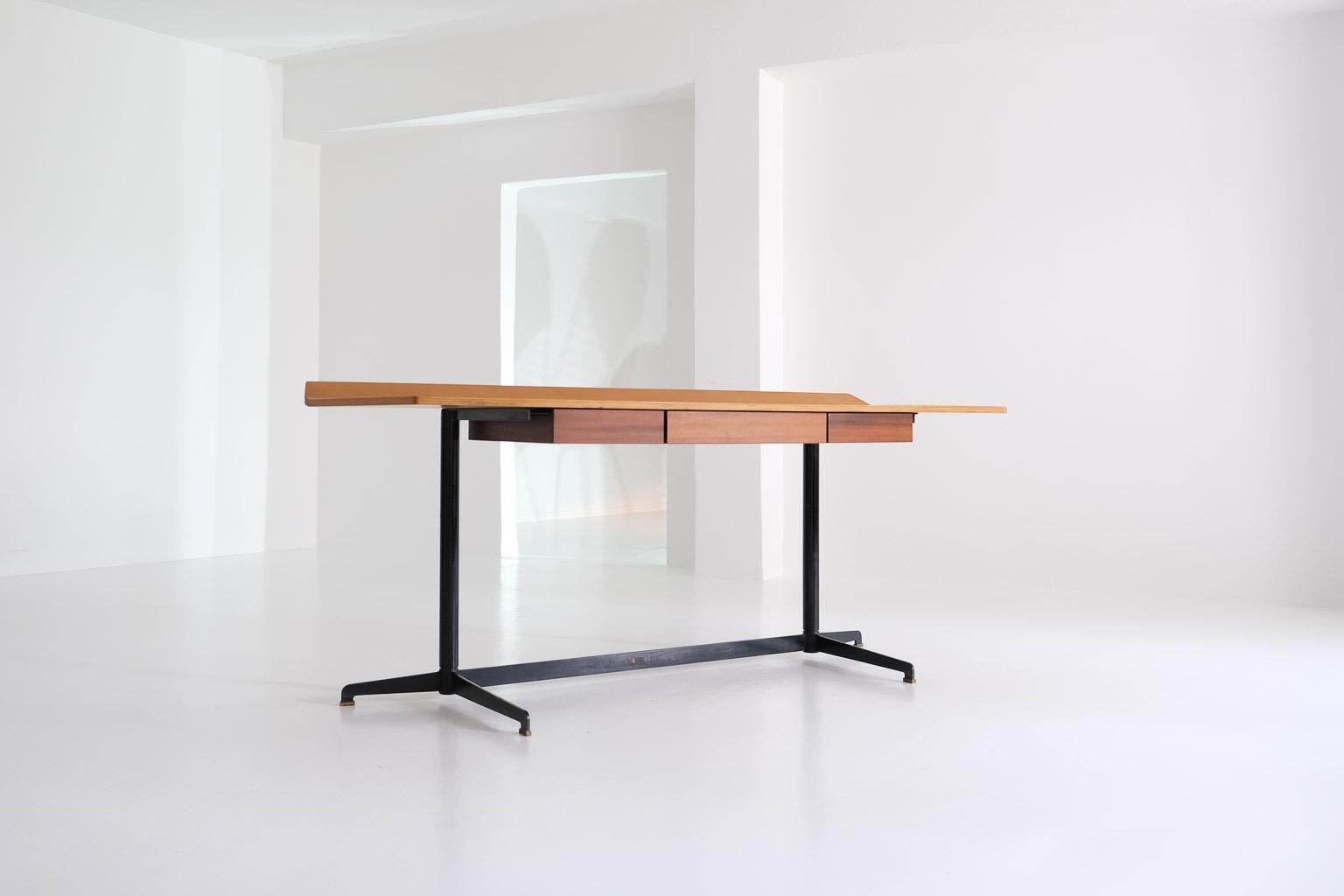 Osvaldo Borsani, early model of t90 desk for tecno, presented at the 10th triennial in 1954, milano, italy. minimalist, elegant – and practical: the raised rear edge of the worktop prevents writing pens from rolling down the back. shaped, curved ply