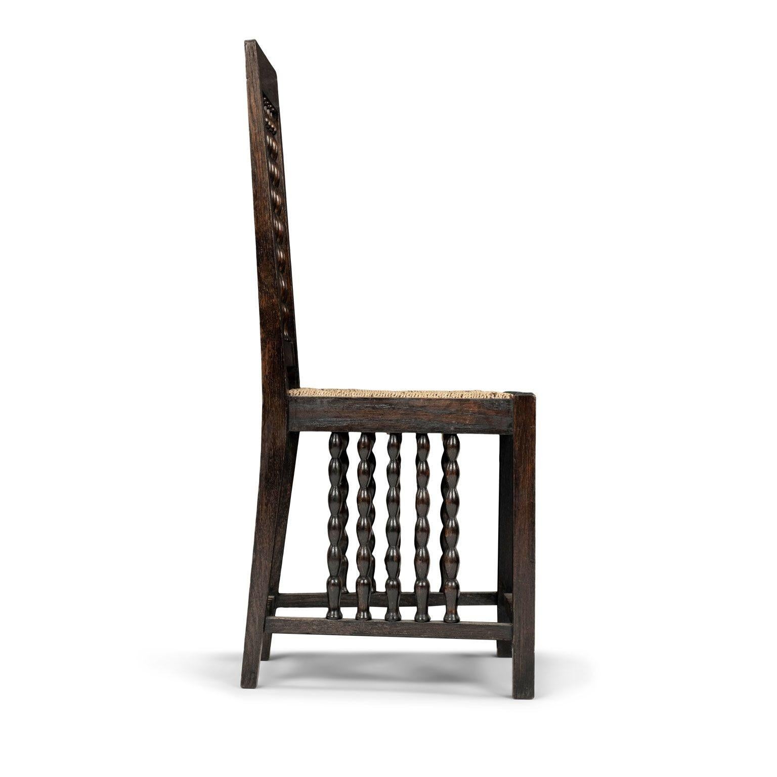 Early modern Jugendstil side chair by Heinrich Vogeler, circa 1910, Germany. Frame carved from blackened oak, square legs (square back legs taper), rushed trapezoidal seat, openwork beaded (bobbin) motif decorates backrest and space between seat and