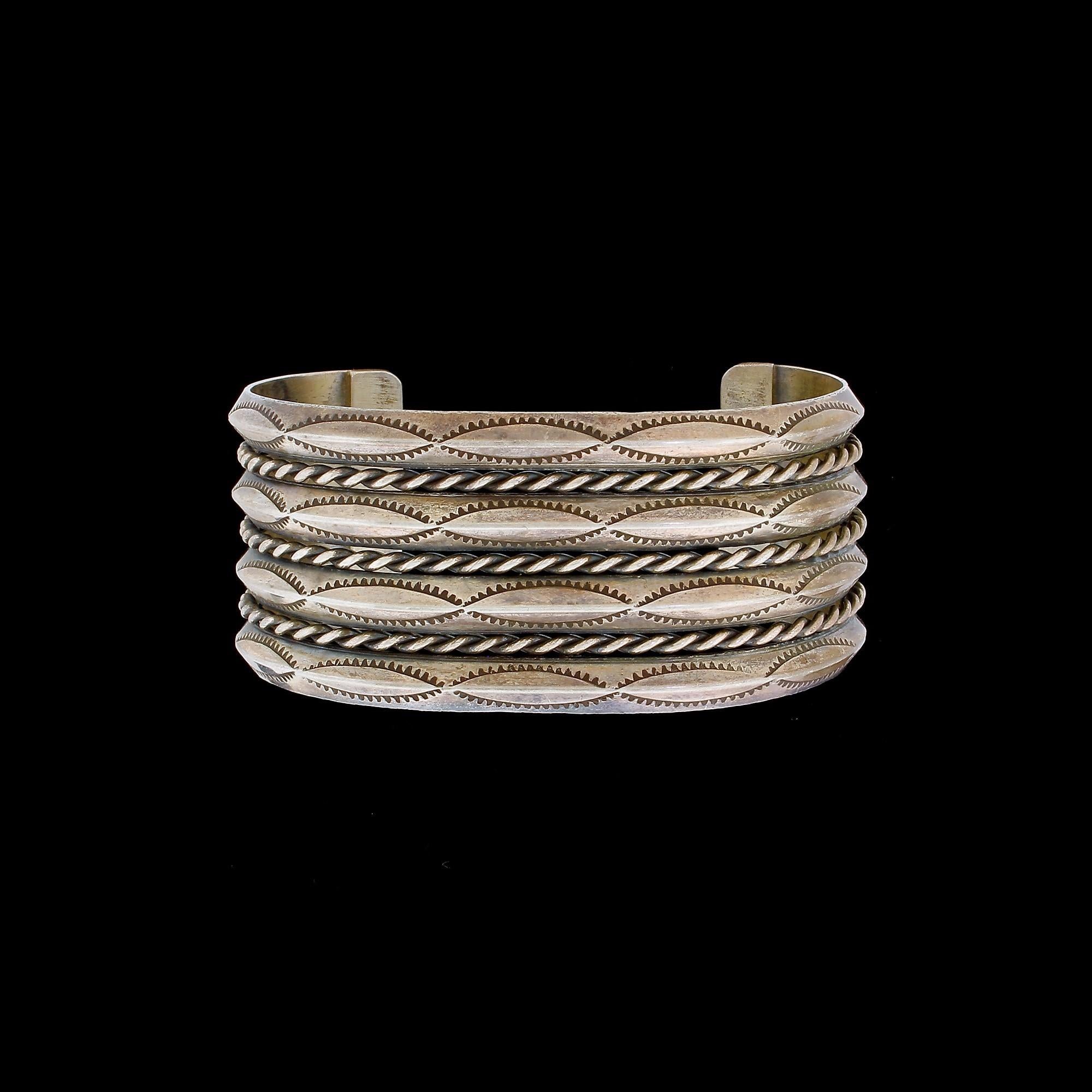 Native American Navajo Indian 900 coin silver hand-stamped 4-row cuff bracelet. This gorgeous wide silver cuff features 4 solid bands with stamp marks and a total of 3 twisted-design silver ropes, one between each band. A high quality unsigned