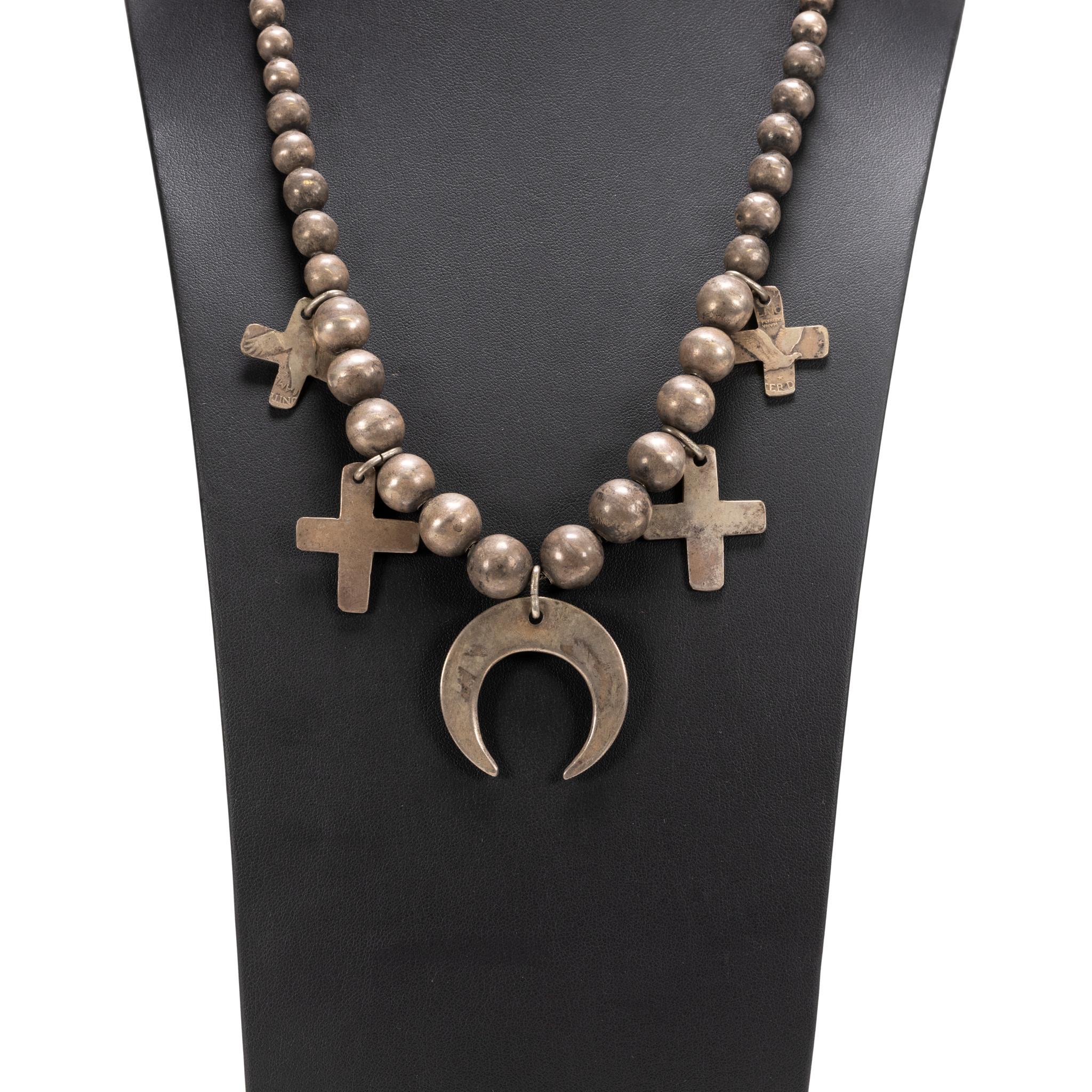 Old Navajo squash blossom with crosses and naja made of hand-filed coins and handmade beads. Made for their own use, turn of the century or before. Simple and important. Purchased from family where it had been for three generations along with three