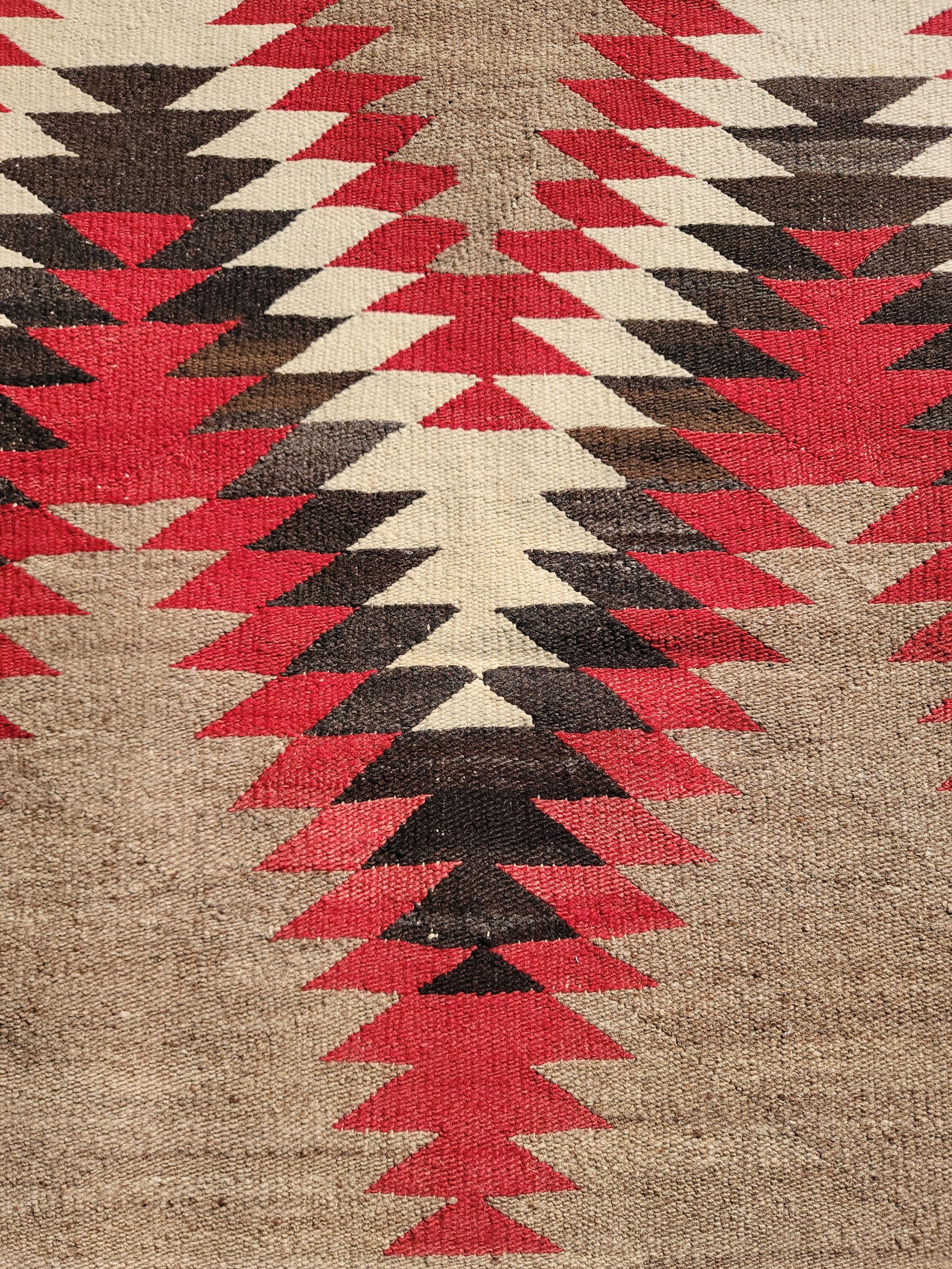 This fine reversible Navajo Indian weaving is in very good condition. One side is faded or muted in colors.