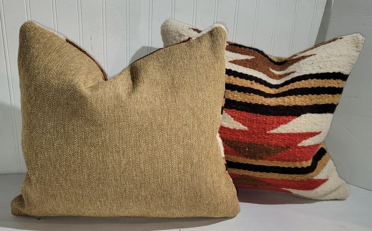 Early Navajo Indian weaving pillows with linen backings. The inserts are down & feather fill.
