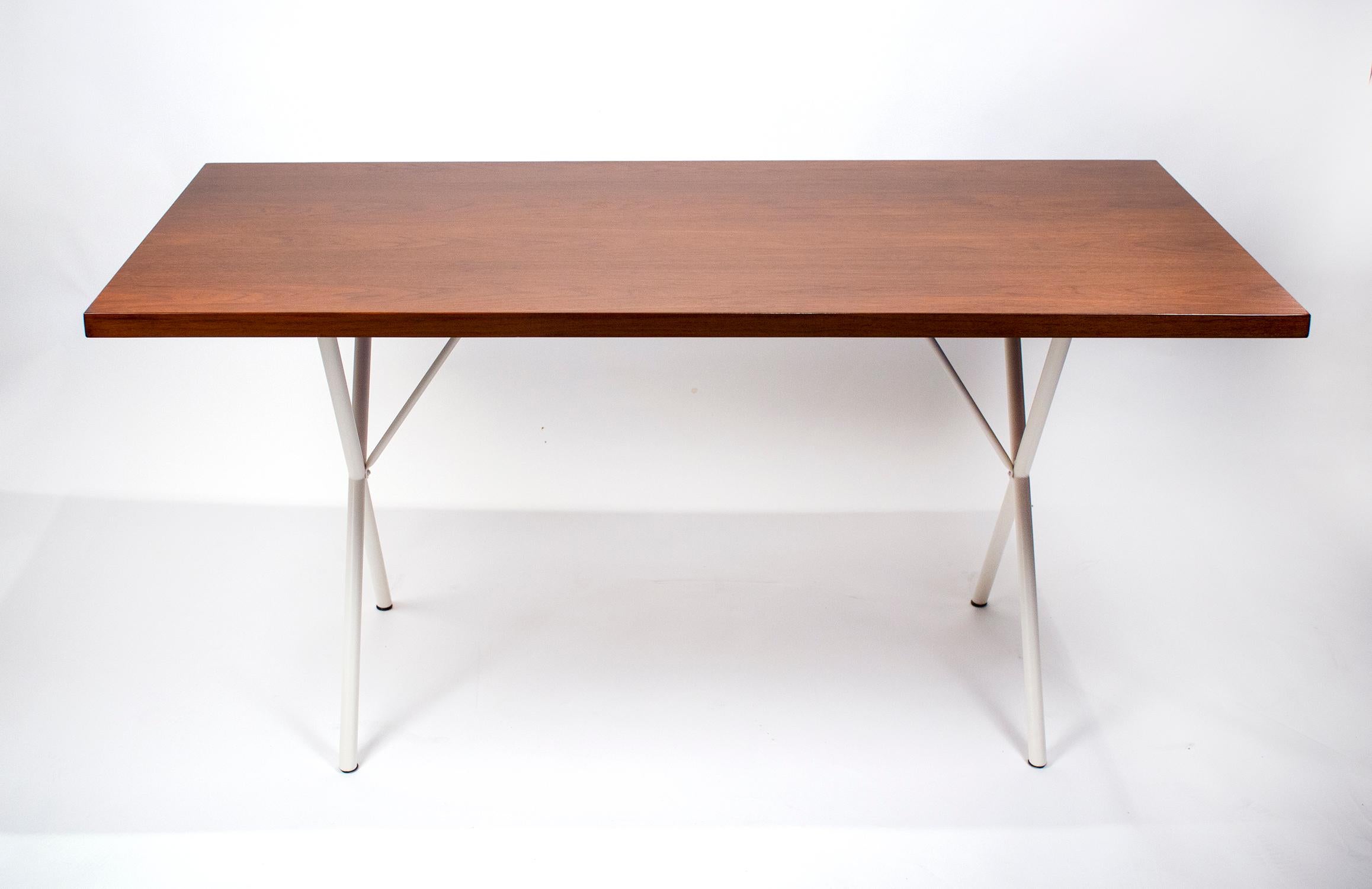 Early production table/desk designed by George Nelson, 1955. This design is very versatile and can function as a desk, an additional work surface, or a dining table. The desk has the original walnut top with lacquered X-base legs and was produced by