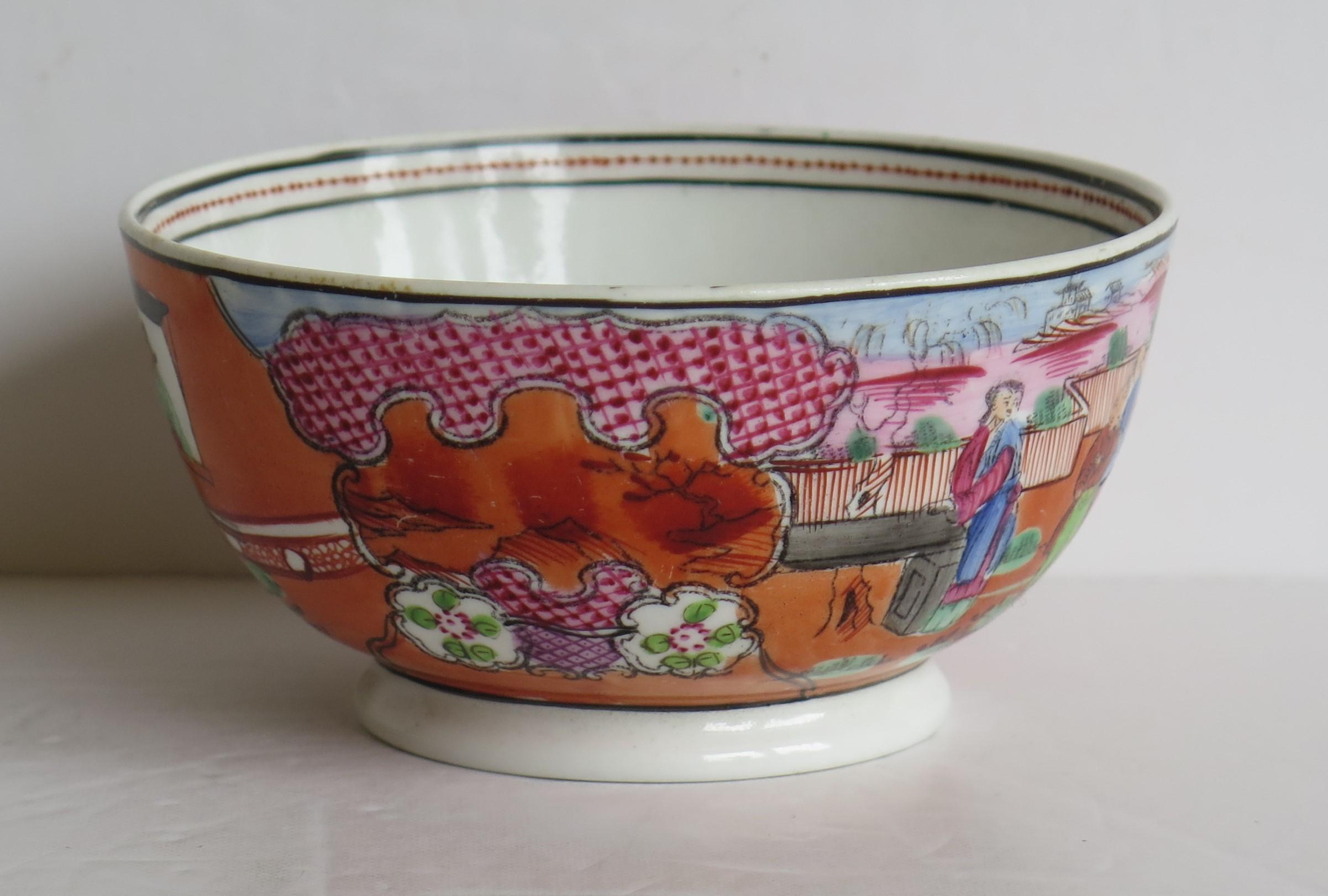 This is a hard paste porcelain bowl by New Hall dating to very early 19th century.

The bowl is well potted on a low foot. 

The decoration is hand-painted in bold enamels in a chinoiserie pattern called 