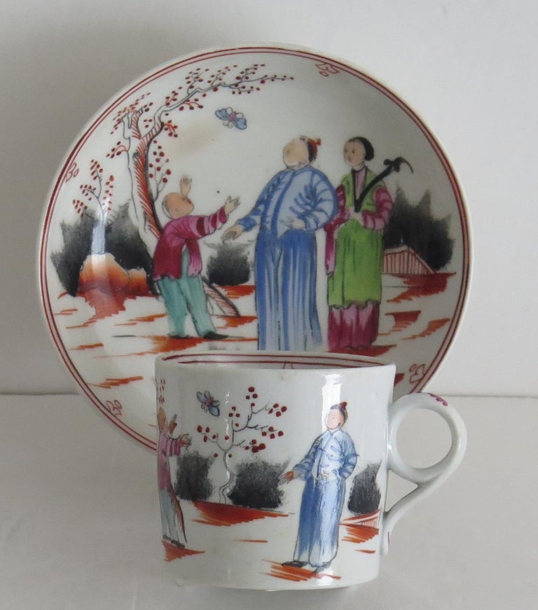 This is a hard paste porcelain coffee can & saucer duo by New Hall, hand decorated with their Chinese figure pattern number 421, dating to the English George 3rd period, circa 1795-1800.

The Coffee Can has their ring handle and is made of hybrid