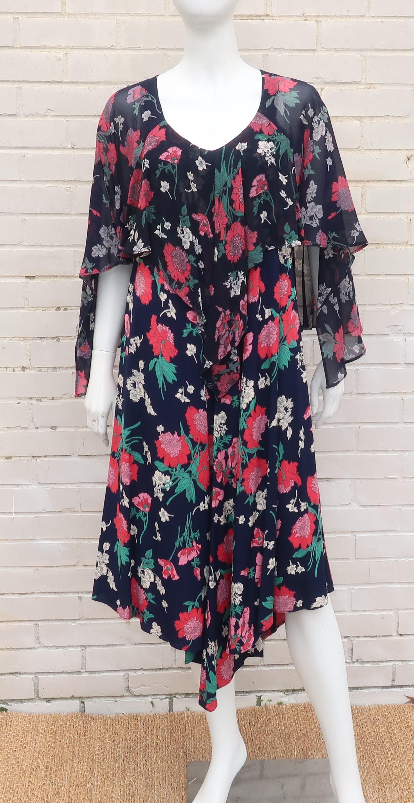 Nicole Miller perfects a boho chic vibe with this 1970's design for the P.J. Walsh label.  The pullover dress is a dark midnight blue (almost black) floral print with accents of red, pink, green, lavender and white in the design.  The body of the