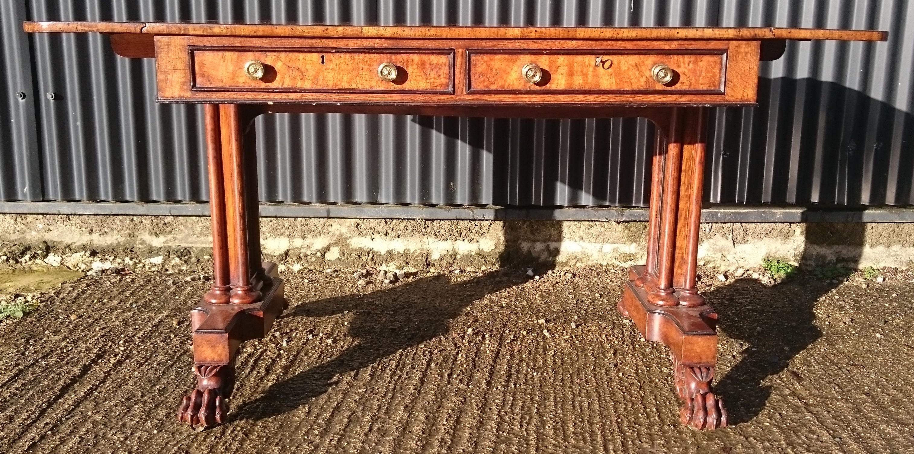 Very unusual and very fine quality Regency sofa table made of burr elm. This table is exceptionally well made, with double lopers to support the ends, end support leg structure, cross banding, stringing, very precise dovetails and very crisp carving