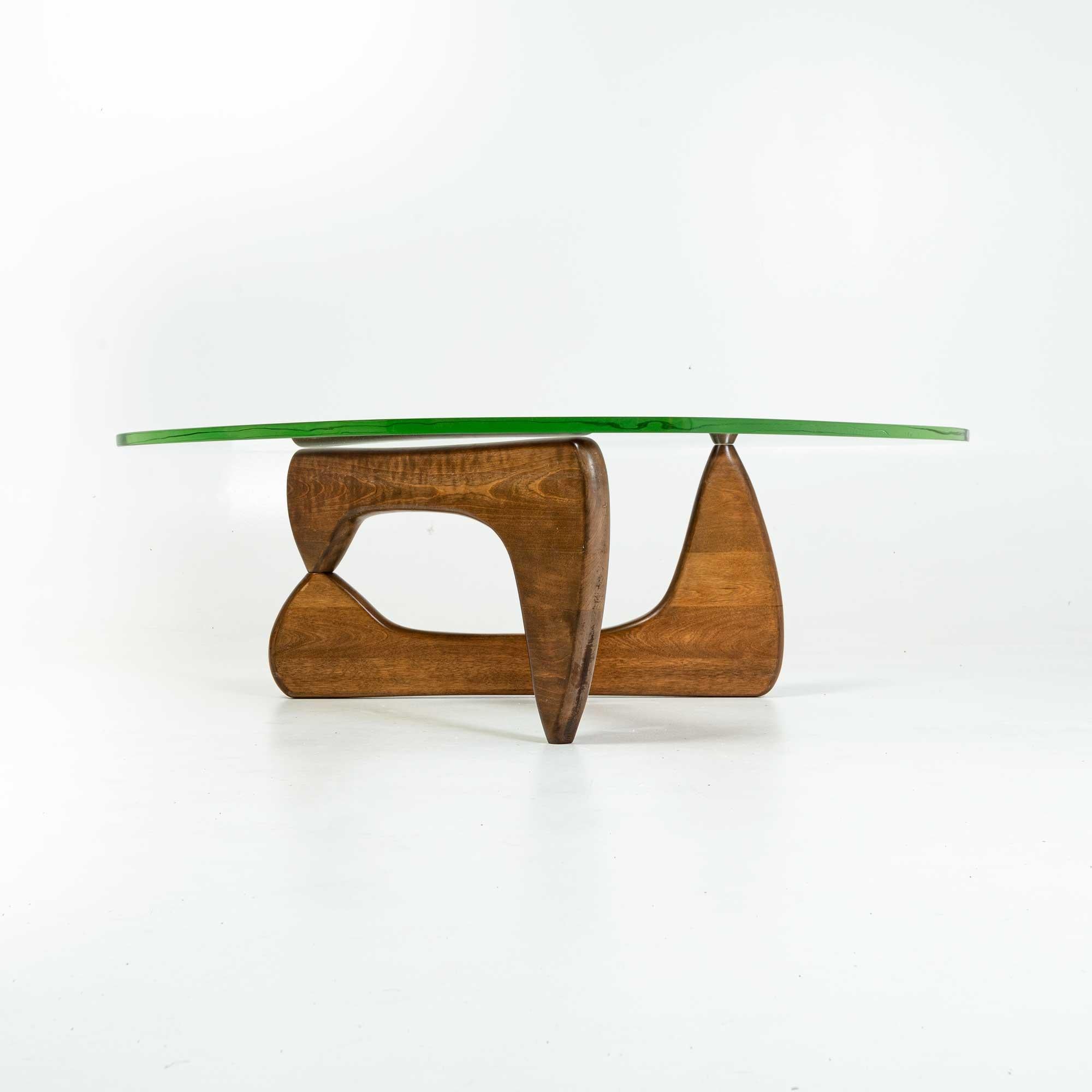 An early Noguchi IN50 coffee table with the original green glass, early 1950s. blonde base with pantina matching age, straight pin ( later pins has locking fins). Some light scratches on the glass, no chips.

Authenticity- this table is guaranteed