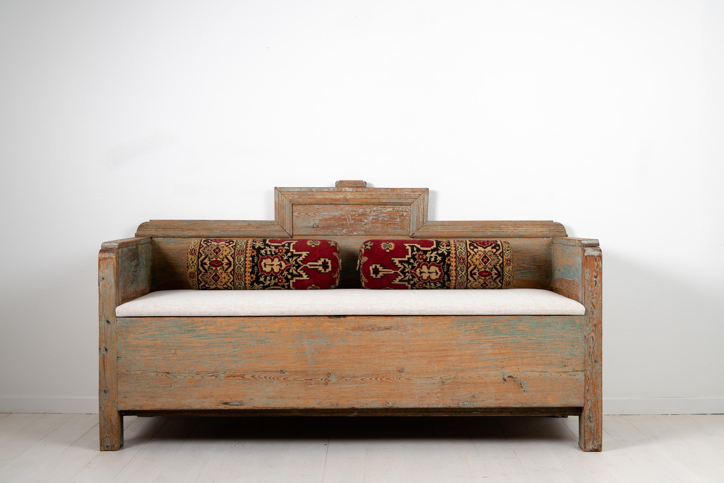 Early country sofa from Northern, Sweden. The straight shape and restrained decor was common during the late 1700s which is around the time the sofa was made. Made in painted pine with traces of the original blue paint. Wooden decor around the crown