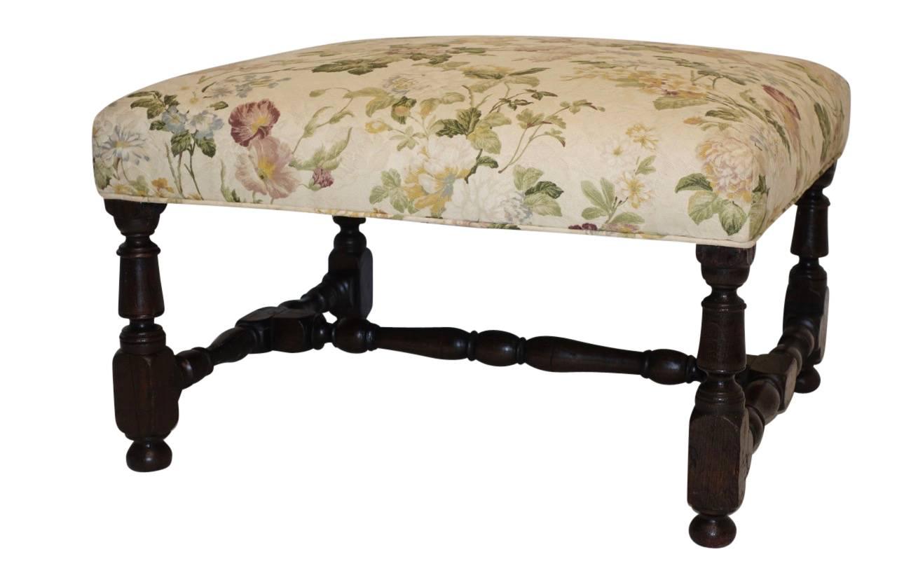 Lovely upholstered oak fireside bench with turned legs and stretcher, England, circa 1760.