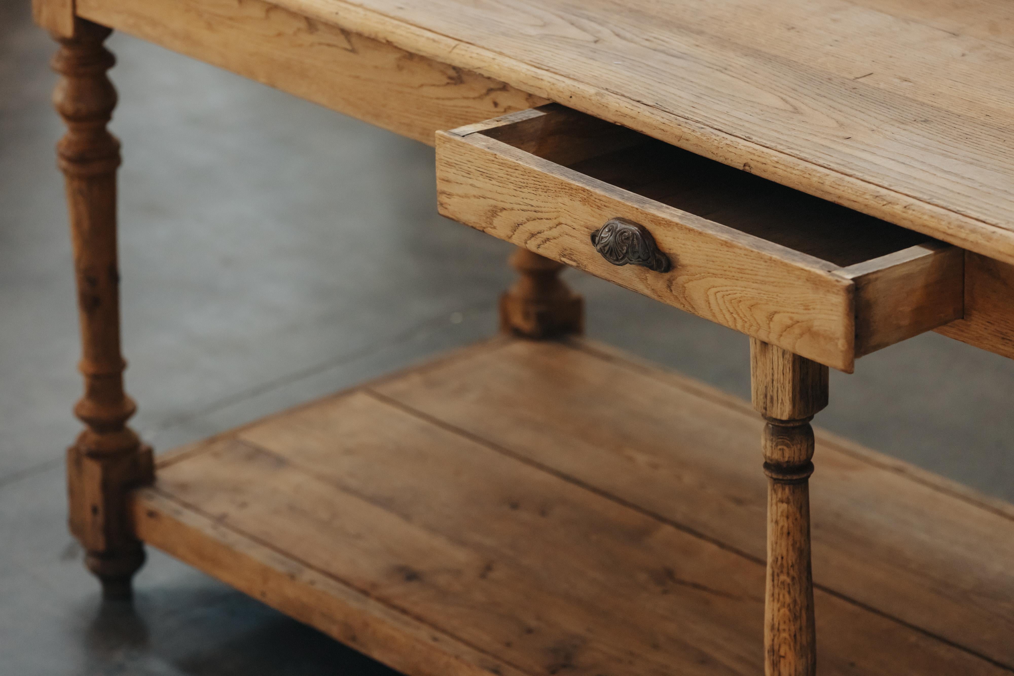 Early Oak Draper Table From France, Circa 1900.  Solid oak construction with one drawer and original hardware.  Light wear and use.
