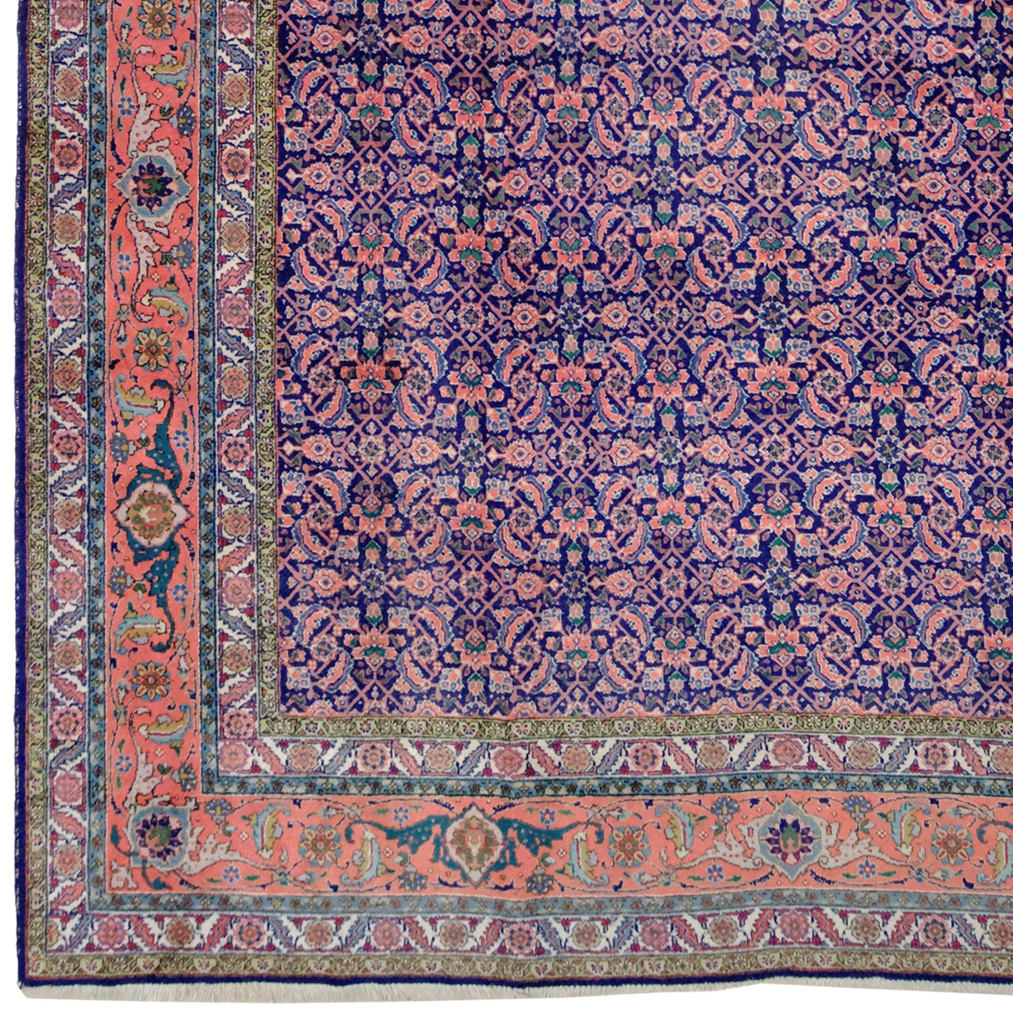 This stunning Tabriz carpet is a rare example of hand-woven carpet dating from the early 20th century. Reflecting classic Tabriz carpet patterns, it stands out with its rich color palette and detailed workmanship.

The carpet's base color is navy