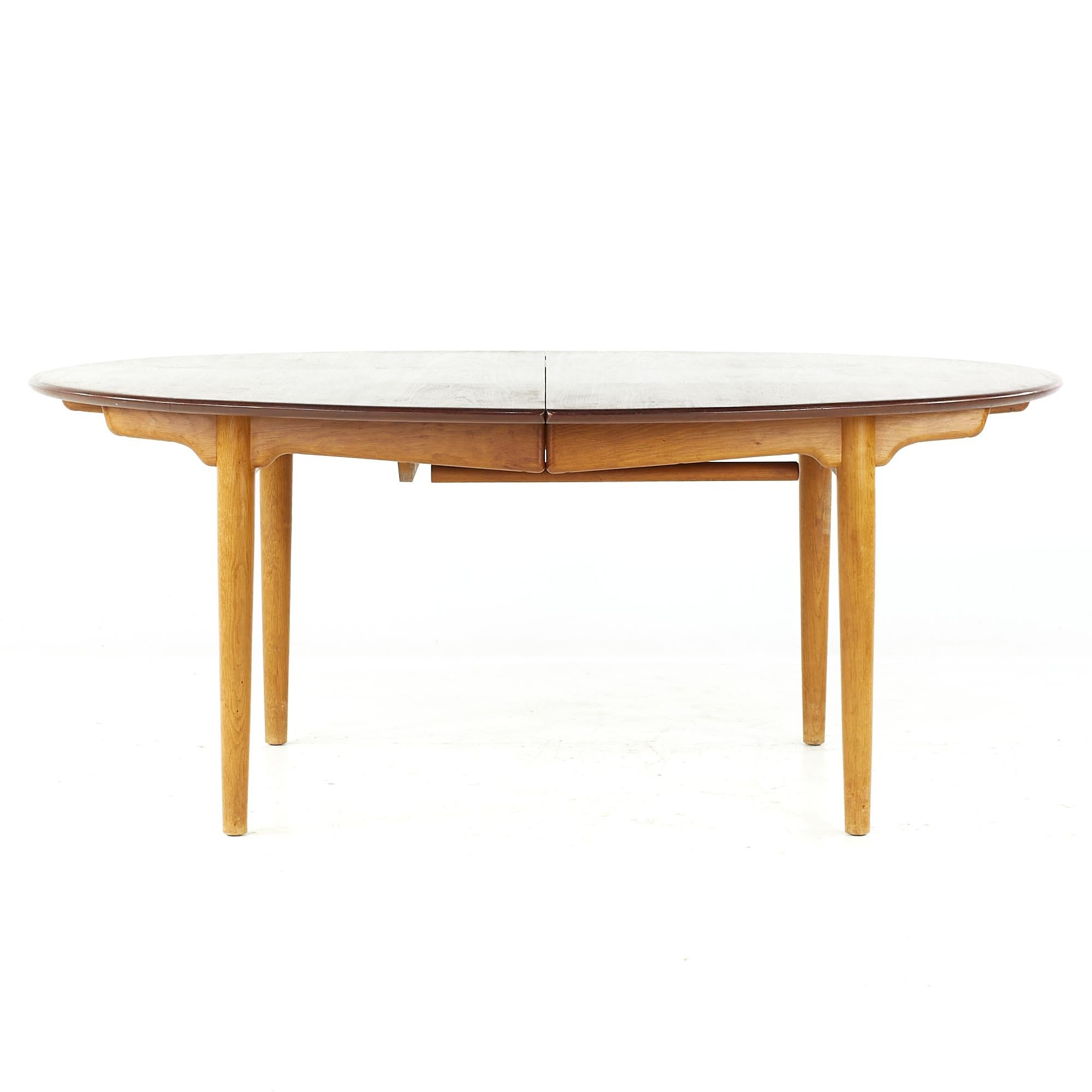 Early Original Hans Wegner for Johannes Hansen midcentury Model JH0567 Teak Dining Table

This table measures: 70.5 wide x 51.5 deep x 28 high, with a chair clearance of 27 inches, three leaves Measure 19.5 inches wide; one leaf measures 11.75