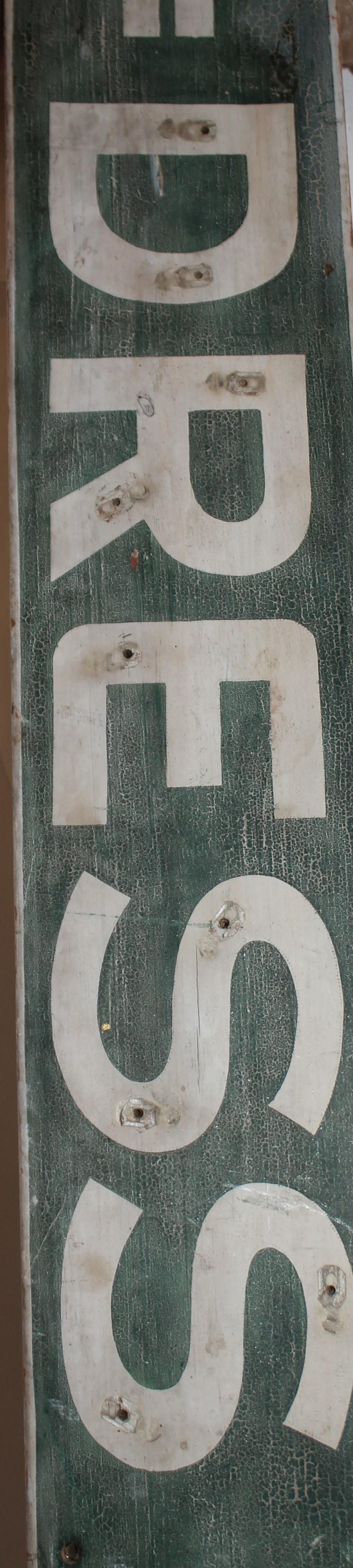 This funky original painted green & white trade sign is in good condition. This sign was taken off a building in New England.