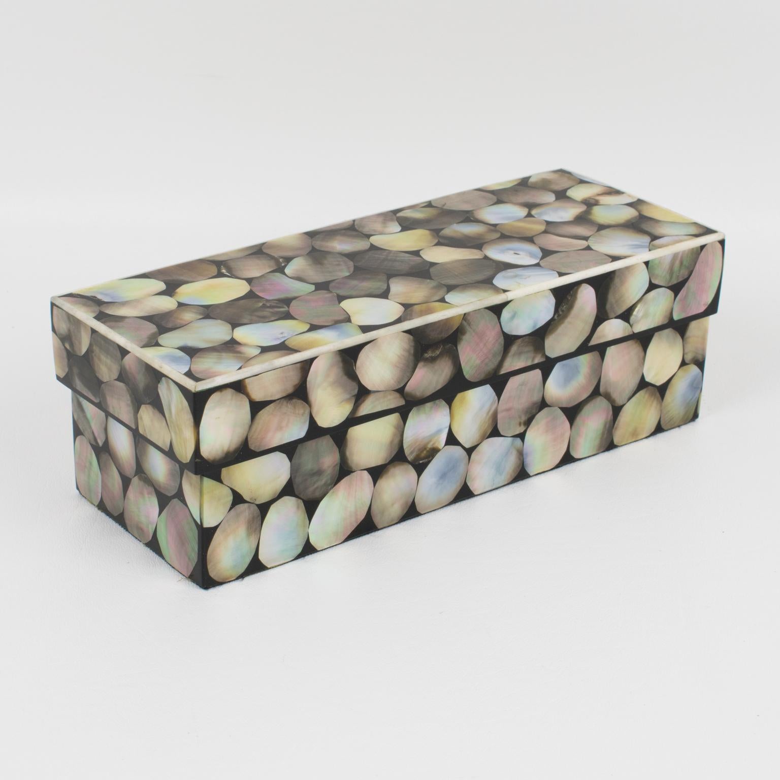 This is an early original lidded box designed by the famed decorative arts design firm Ria & Youri Augousti, Paris. The rare piece boasts geometric seashell marquetry with trim accents on a wood body. The stunning box is marked on the underside R&Y