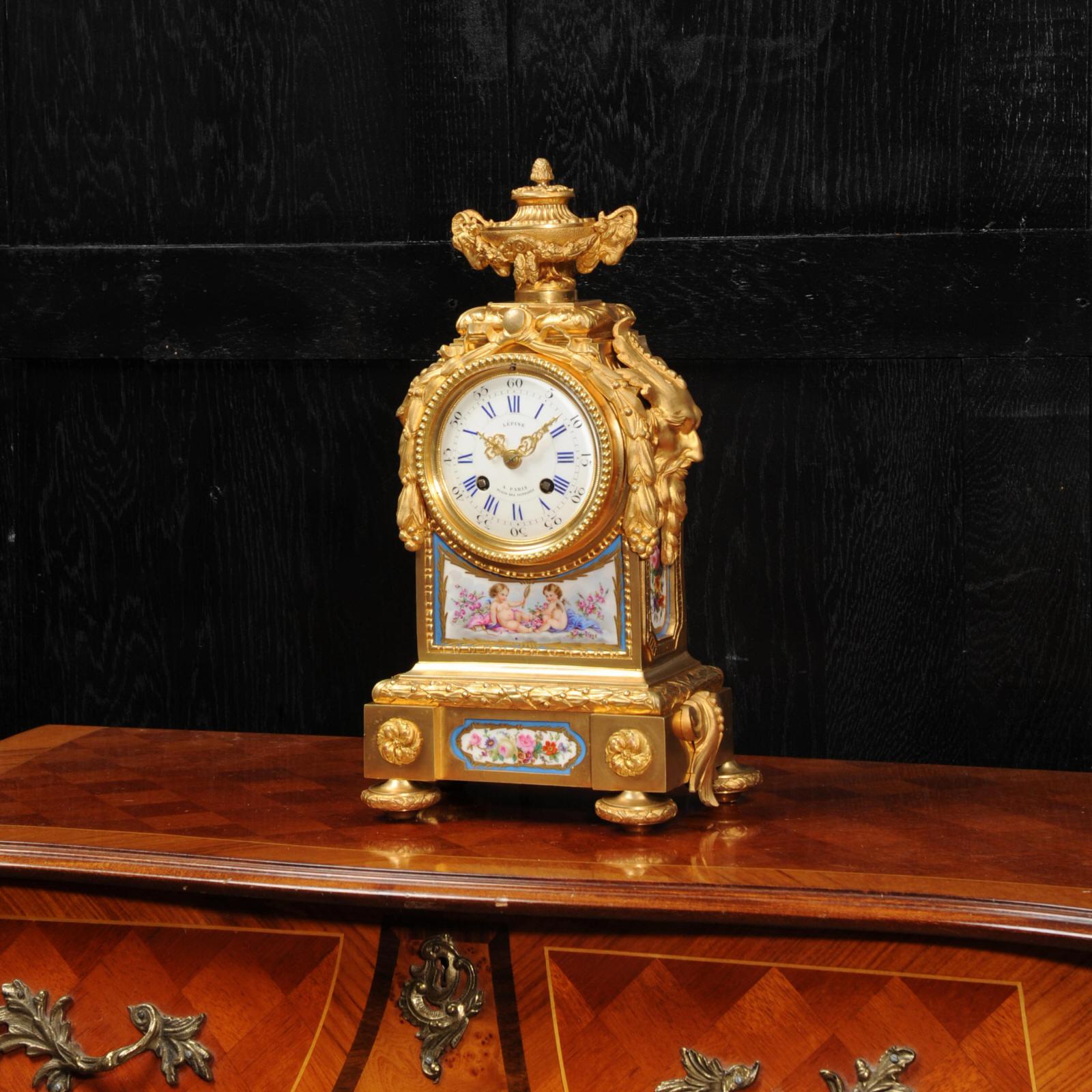 A fine and early clock by Lépine Paris, circa 1840. It is beautifully made in ormolu (finely gilded bronze doré) and mounted with exquisite Sèvres style porcelain with a blue ground. The panel below the dial features an exquisite scene of two winged