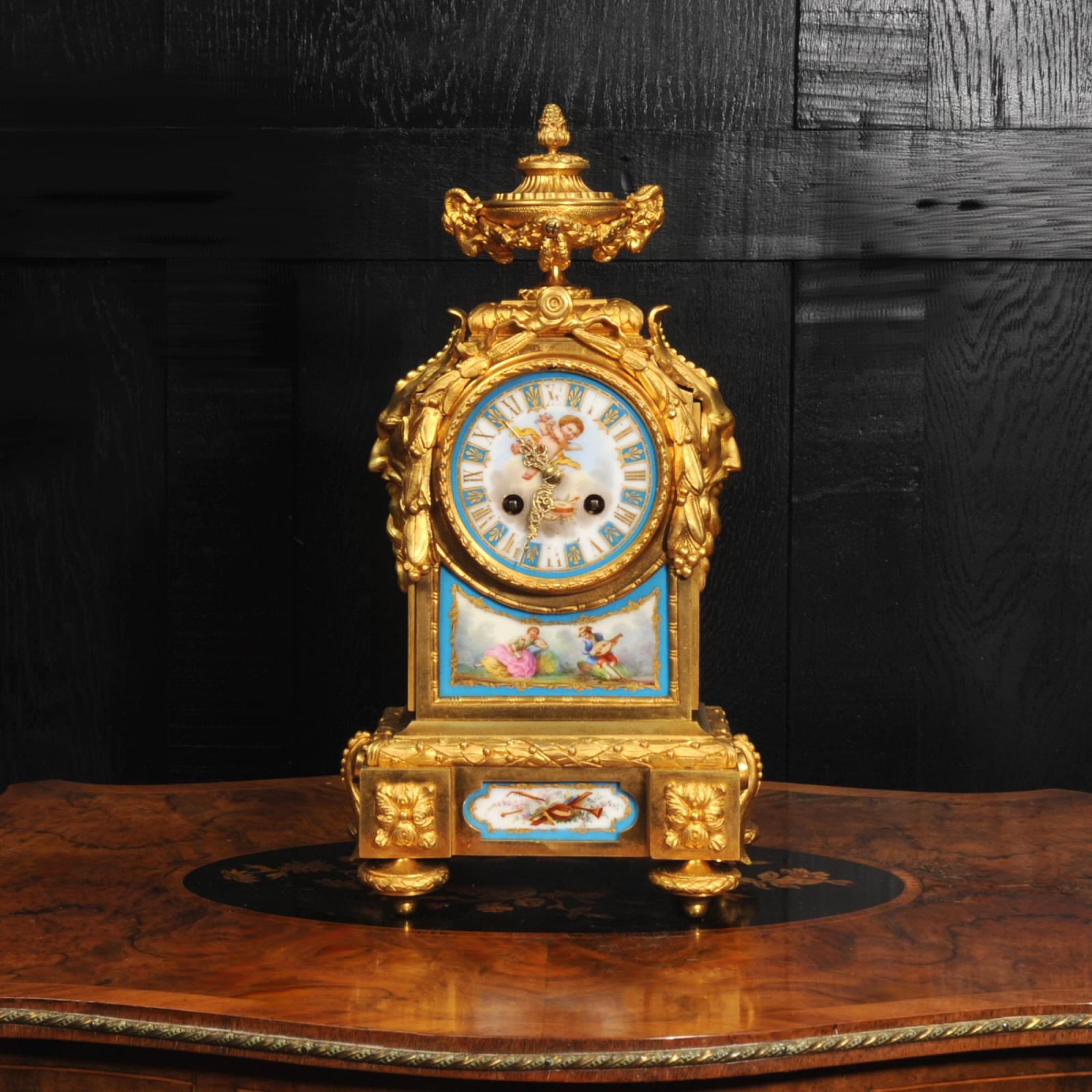 A fine and early clock by Japy Fils. It is beautifully made in ormolu (finely gilded bronze doré) and mounted with exquisite Sèvres style porcelain with a blue celeste ground. The panel below the dial features an exquisite scene of a couple in a