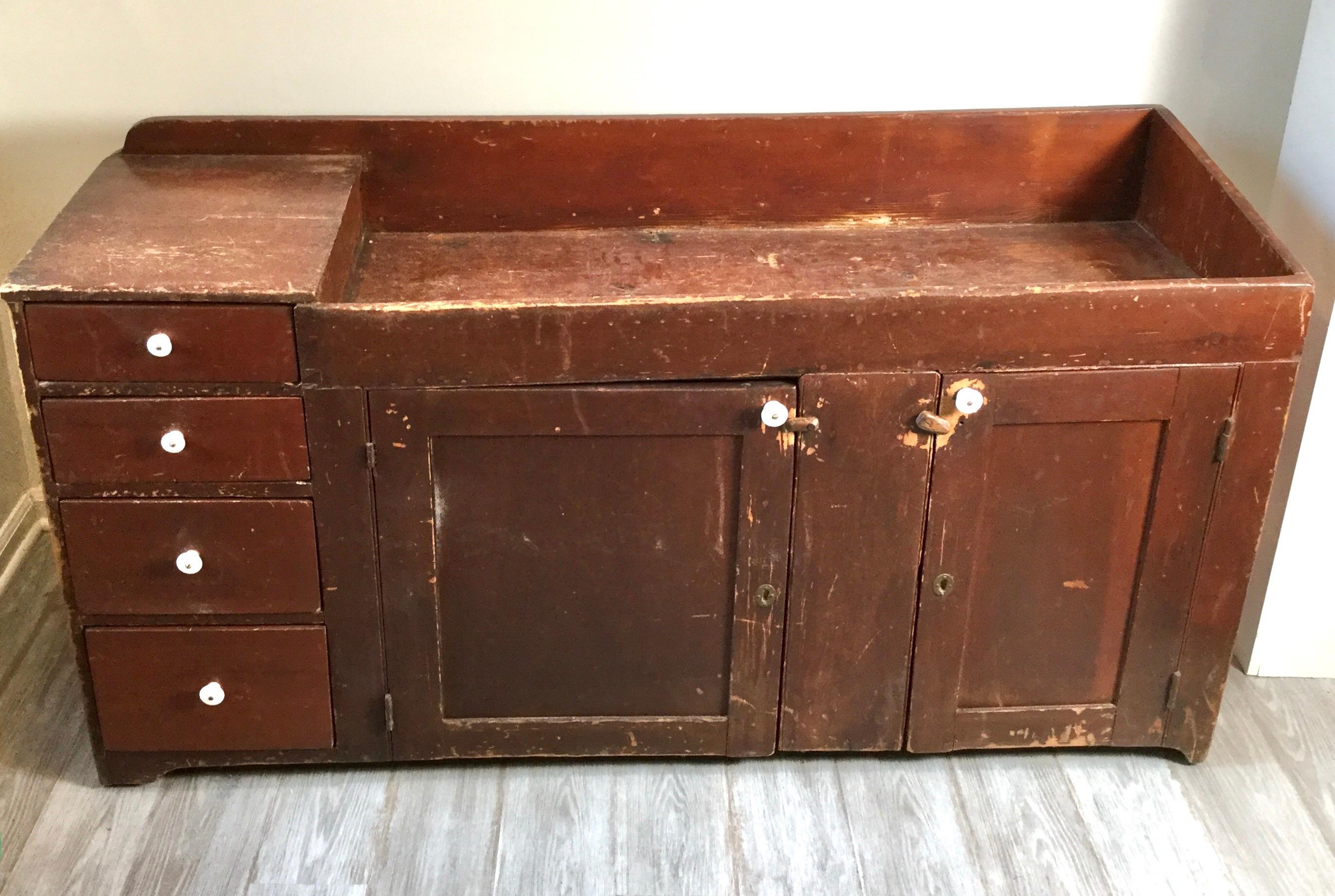 Early painted primitive pine dry sink. Unusual size with 4 drawers down the side on left and 2 cabinet doors. Original paint, circa 1830s.