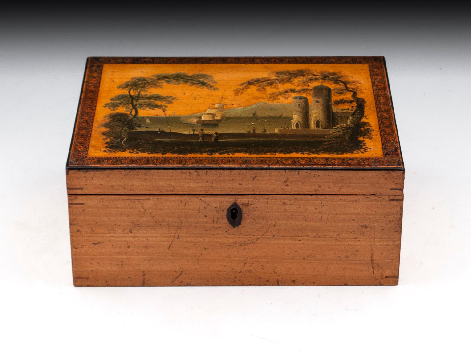 Antique early tunbridge sycamore box with a superb painted view of a coastal landscape framed by transfer ware border. 
The interior is lined with it original red paper and comes with a fully working lock and tasselled key. 
To unlock the box the
