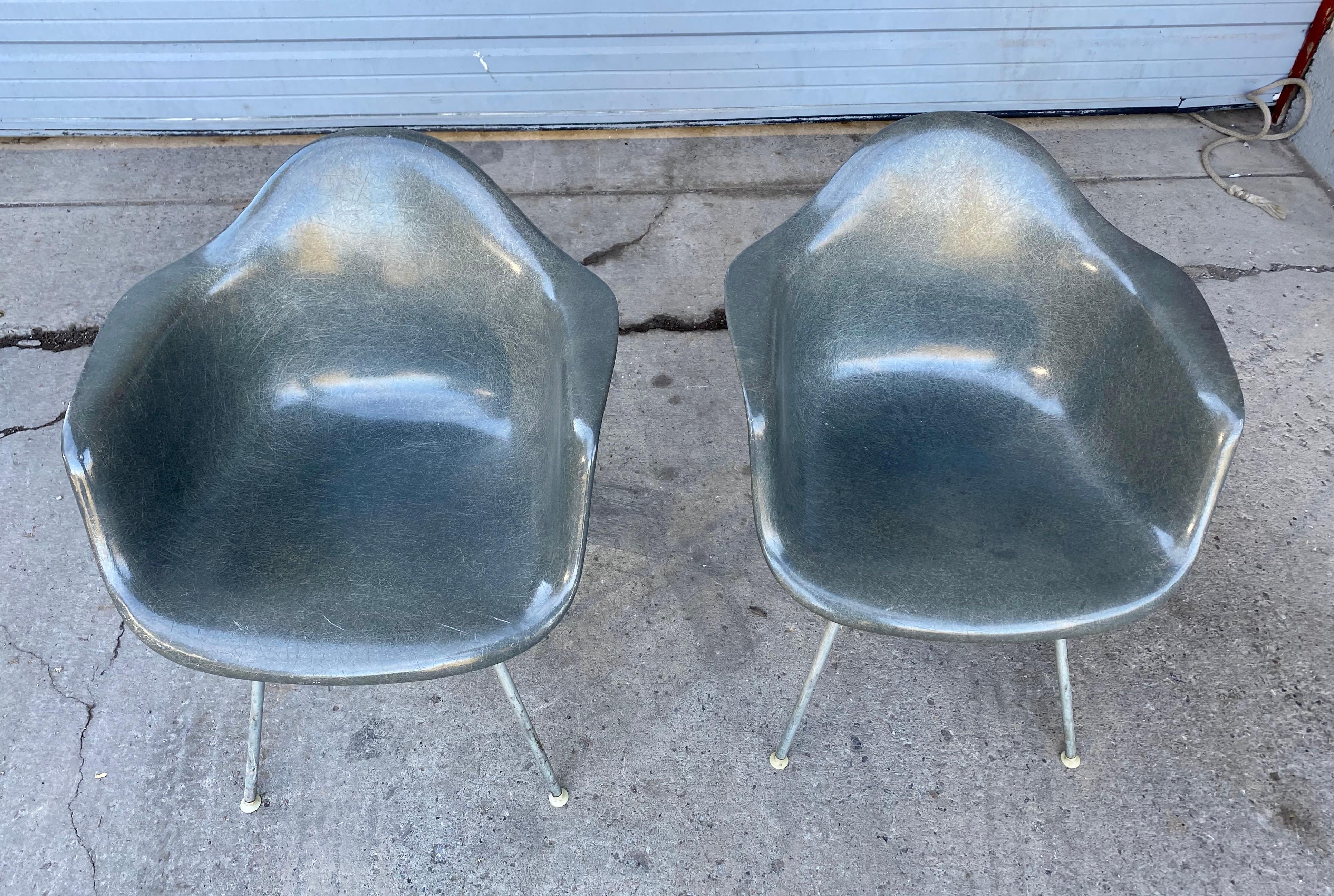 Early pair of Charles Eames fiberglass arm shell chairs 