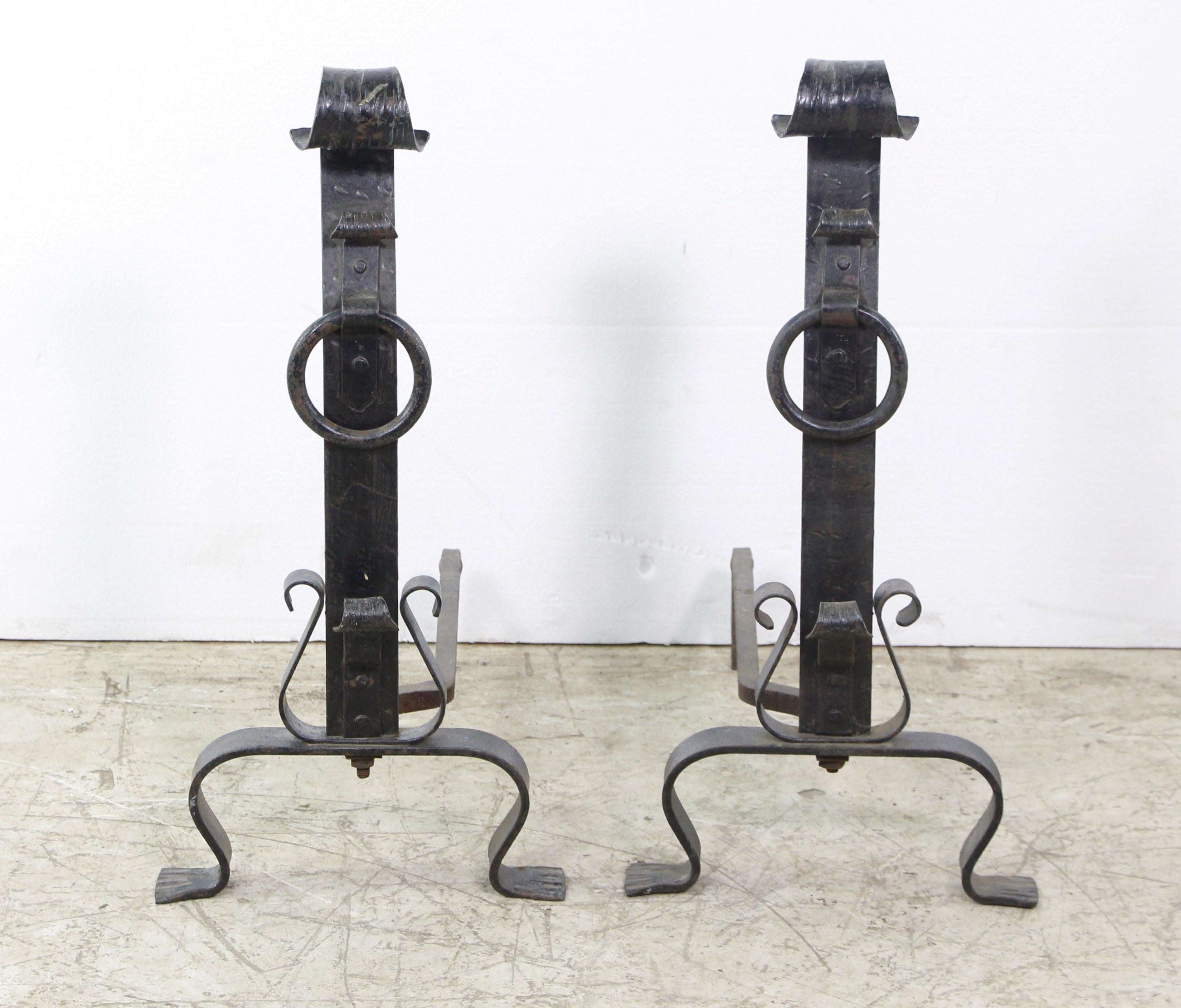 Pair of late 1890s or early 20th century hand made wrought iron andirons. Featuring a spiral design on top. Hand hammering and chiseled designs throughout.