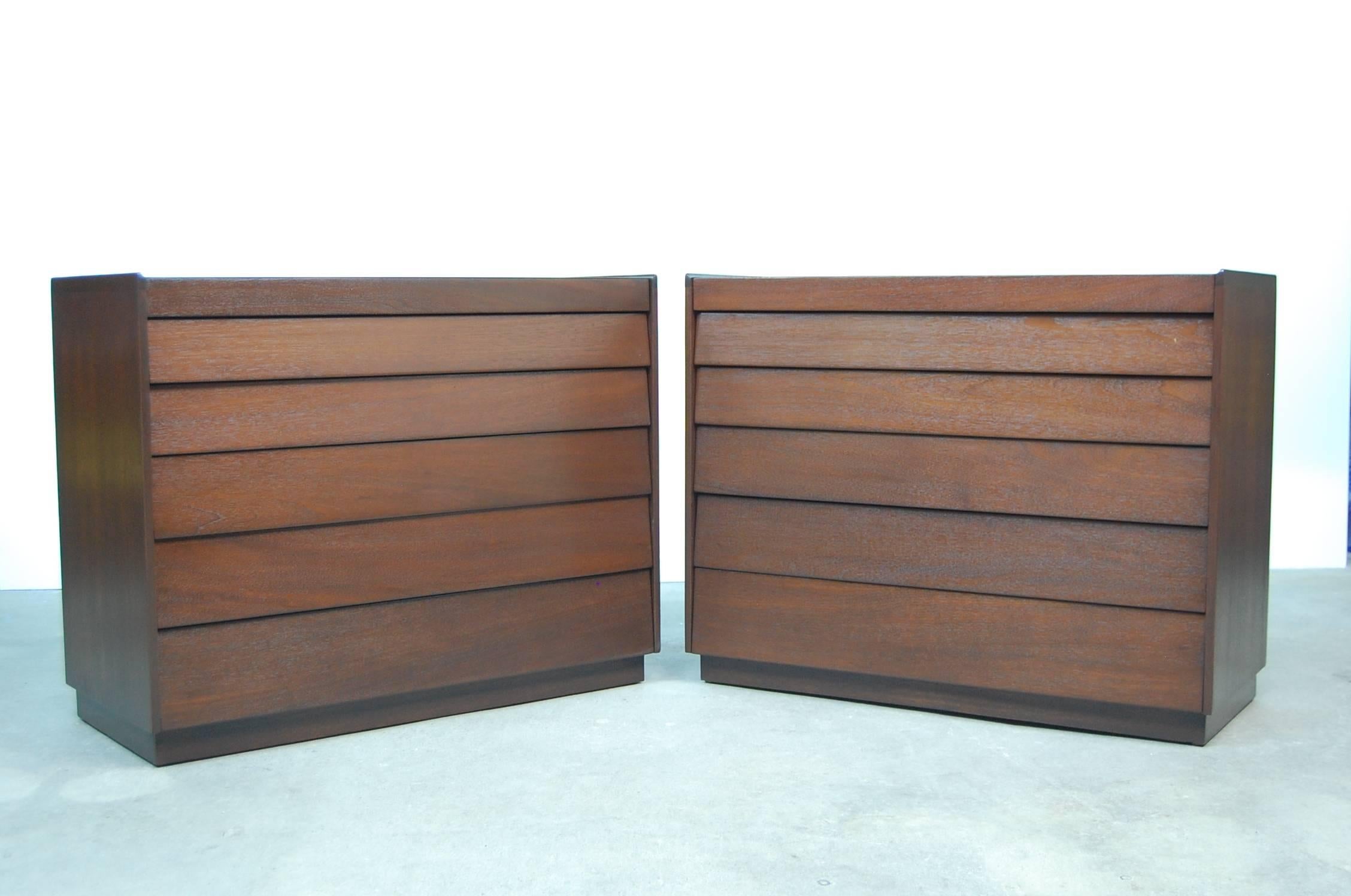 Pair of mahogany louver front dressers, designed by Edward Wormley, circa 1952. Produced by Dunbar. Professionally refinished. Each chest has a small gallery edge on three sides, and sits on a plinth base. Measure: 42