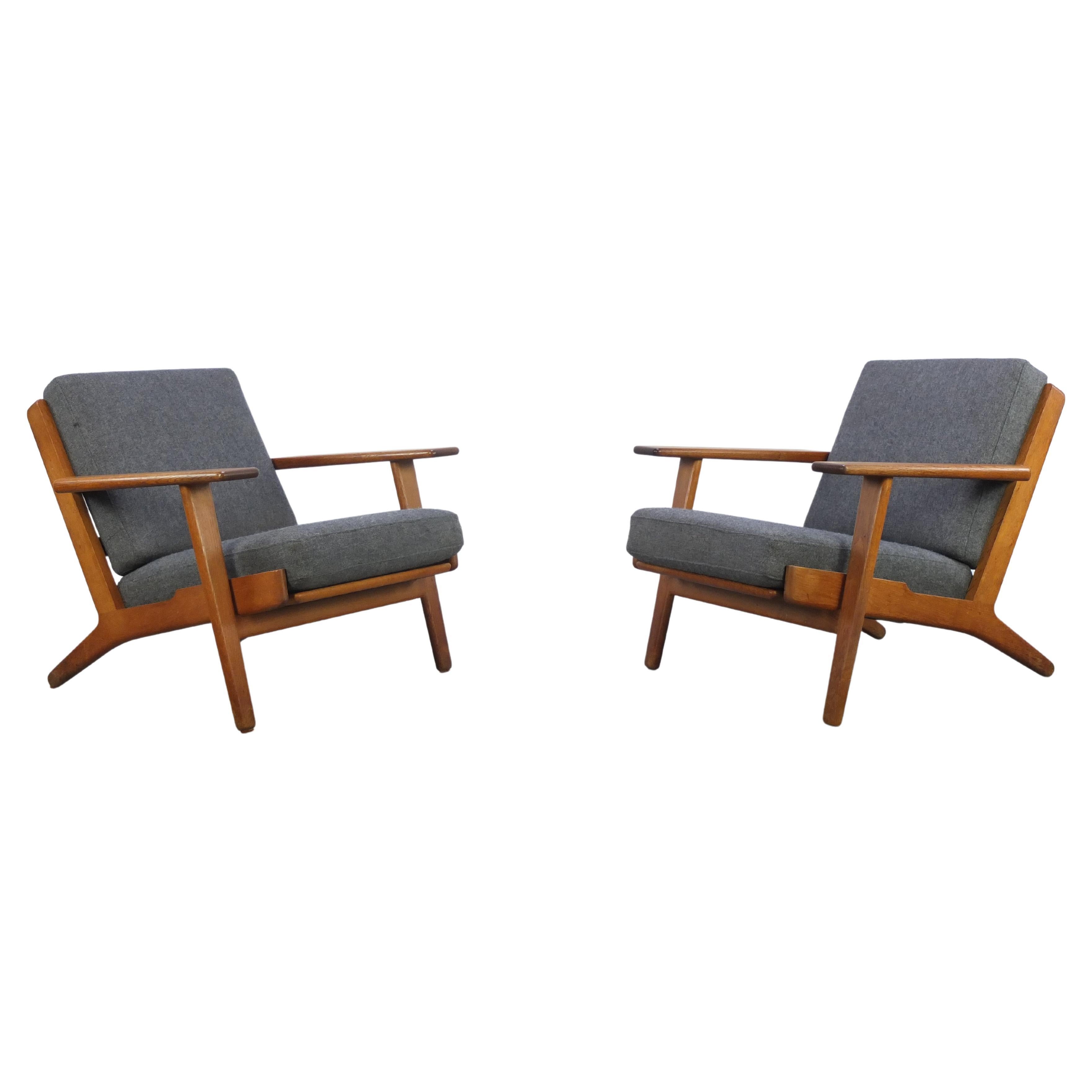 Straight from Denmark I brought back this fantastic pair of lounge chairs designed by Hans Wegner in 1953. They are called model ‘GE-290’ with solid oak frames and the original blue-grey cushions. The oak has a wonderful patina thanks to age and