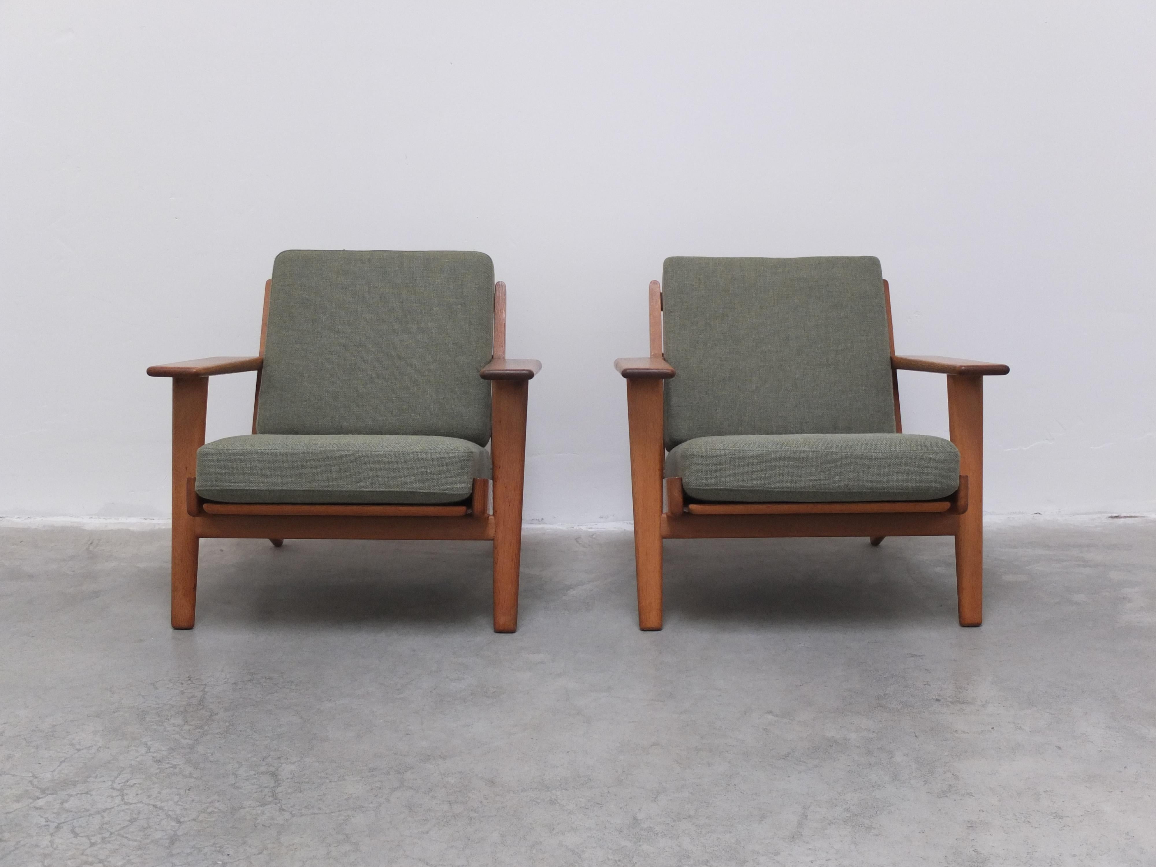 Straight from Denmark comes this original pair of lounge chairs designed in 1953 by the master himself, Hans J. Wegner. This is model ‘GE-290’ with solid oak frames and the original green spring cushions. The oak has a wonderful patina thanks to age