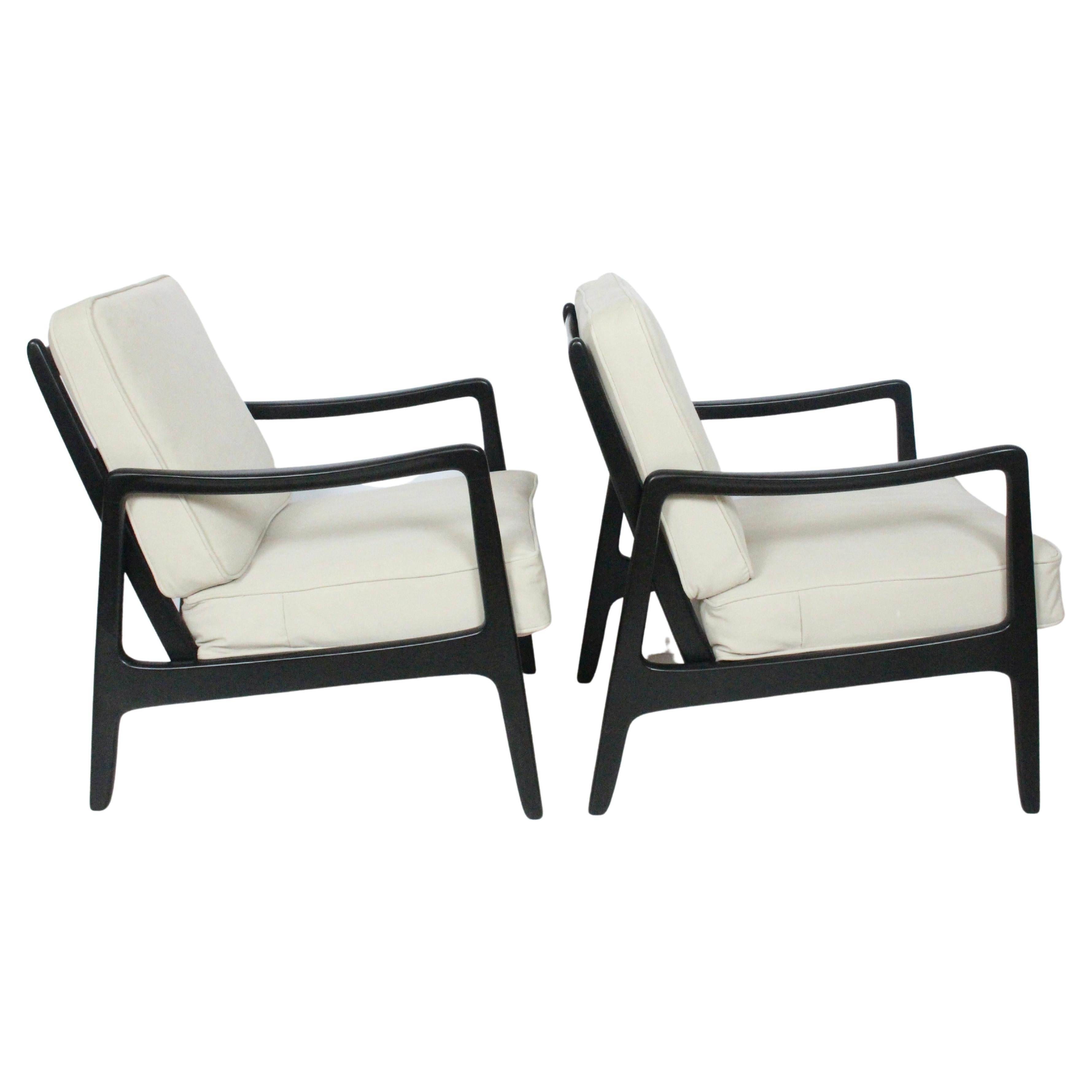 Danish Modern pair of solid ebonized Cuban Mahogany lounge armchairs by Ole Wanscher designed for France and Daverkosen distributed by John Stuart. Featuring solid, sturdy newly ebonized mahogany and angled ladder back style framework for ultimate