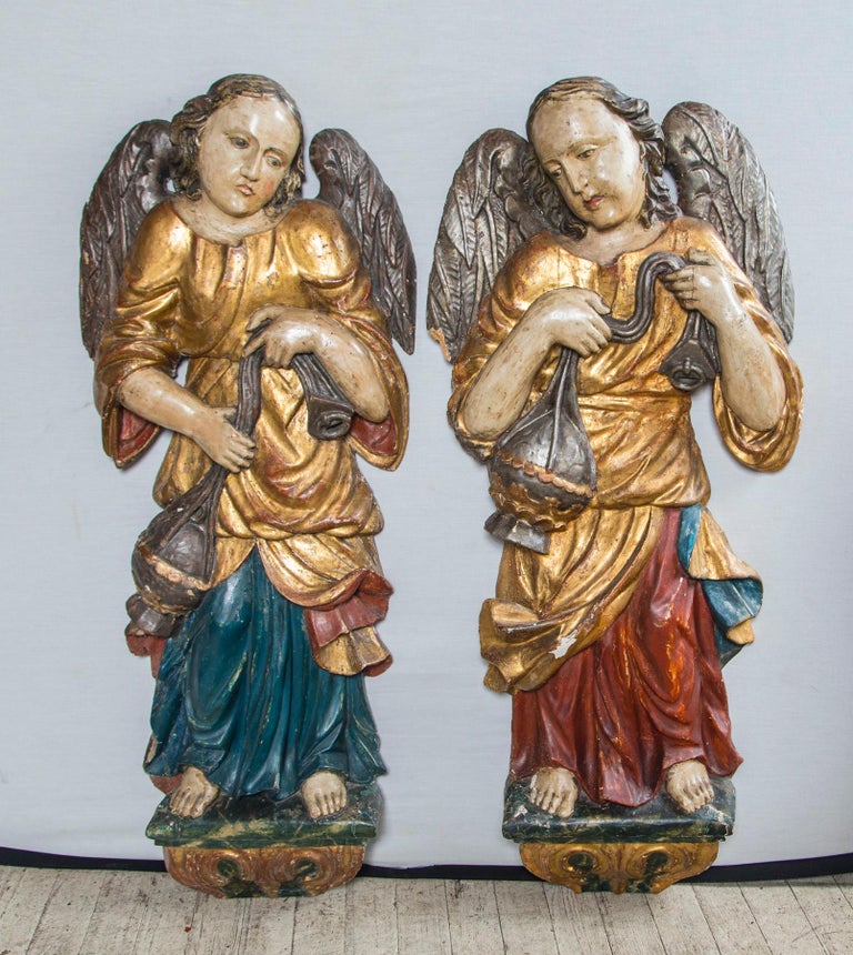 Gold gilt and silver gilt with polychrome paint
Flat backs, showing worming and restorations
one is 17 inches wide, the other, 16
we believe them to be from either Italy or Spain.