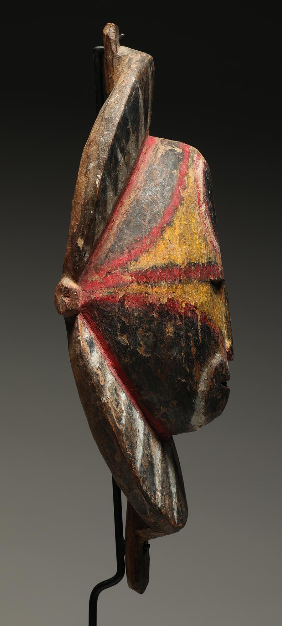 Early Papua New Guinea Sepik hard wood yam mask with areas of yellow, red, black and white pigments. Expressive face.
Mask is 8 1/2 inches high, on custom metal base total height 12 inches.

