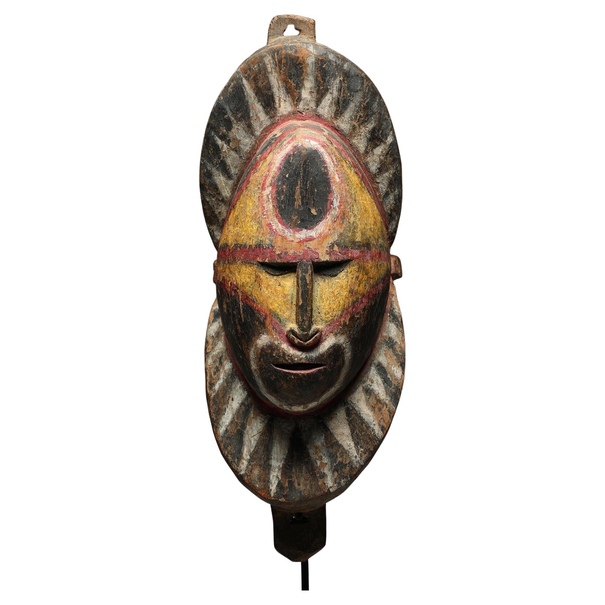 Early Papua New Guinea Sepik Wood Yam Mask Yellow Red and Black on Custom Base For Sale