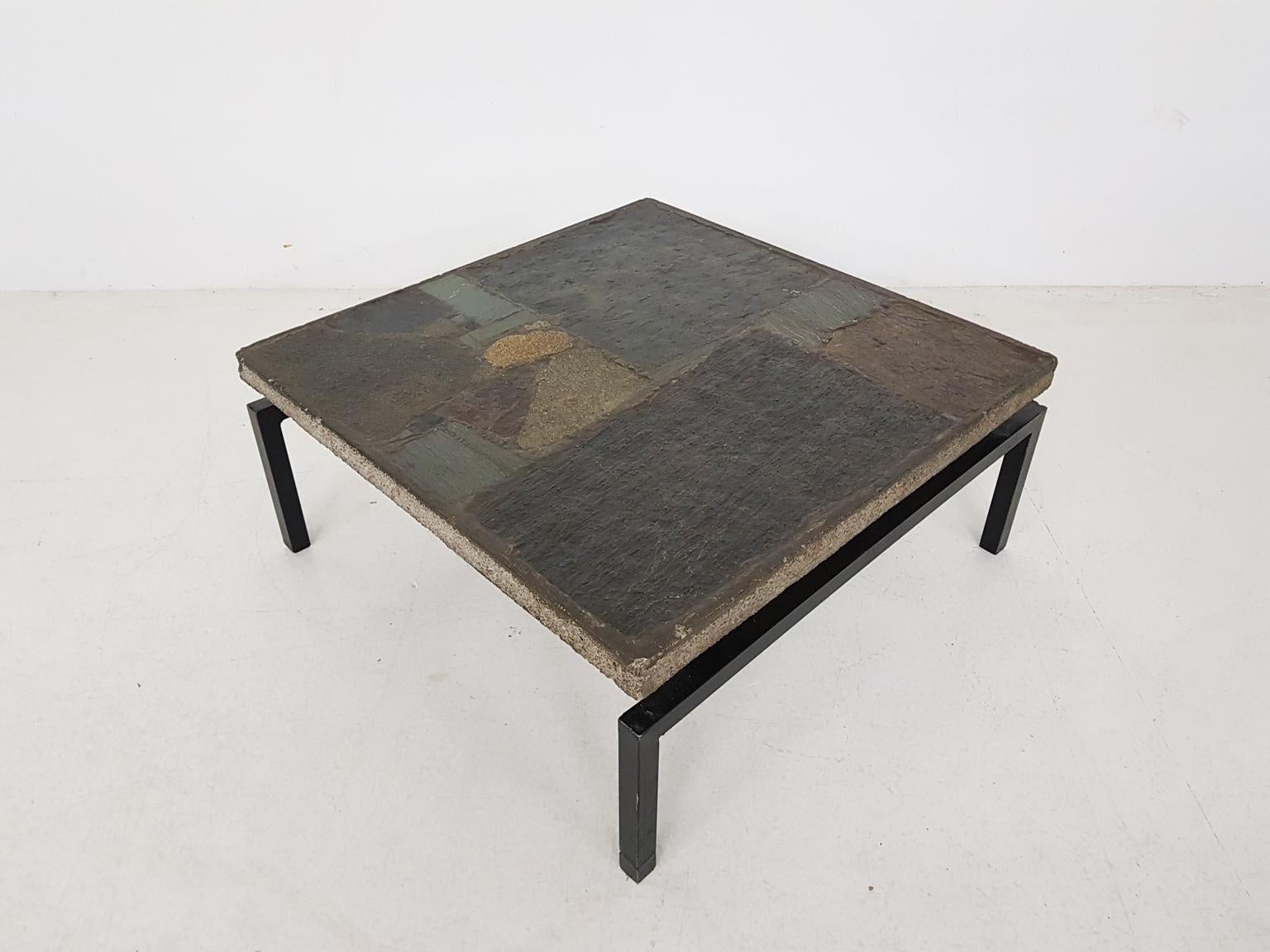 Impressive concrete coffee table on a black metal base with mosaic inlay by the Dutch sculptor Paul Kingma. Made in 1963 in the Netherlands.

Like all coffee tables made by Paul Kingma, this one is hand made with materials he carefully collected.