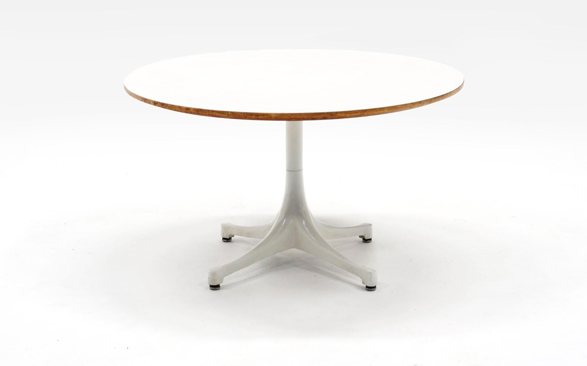 Round white pedestal coffee / side table designed by Irving Harper for the George Nelson Office and made by Herman Miller between 1954-1957. Signed with the early Herman Miller George Nelson round white metal medallion. White laminate top and