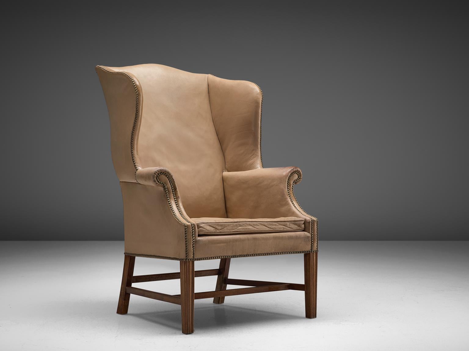 Early Peter Hvidt & Orla Mølgaard Nielsen, wingback chair, patinated leather, mahogany and brass, Denmark, 1940s

Danish wingback chair with a classic design, by Peter Hvidt & Orla Mølgaard Nielsen in the 1940s. This ornate, royal lounge chair is