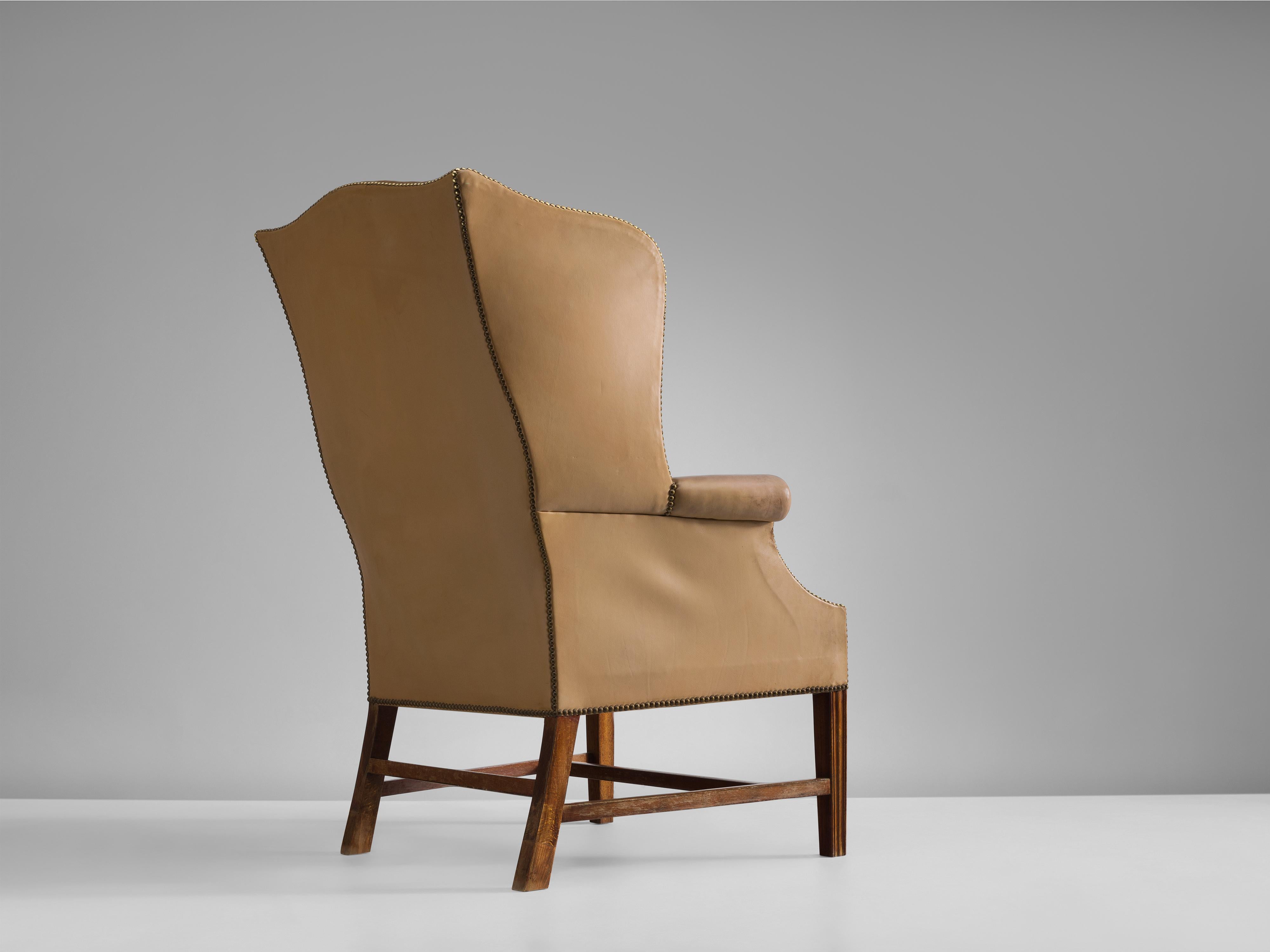Peter Hvidt & Orla Mølgaard Nielsen, wingback chair, patinated leather, mahogany and brass, Denmark, 1940s

Danish armchair with a classic design, by Peter Hvidt & Orla Mølgaard Nielsen designed in the forties. This ornate, royal lounge chair is