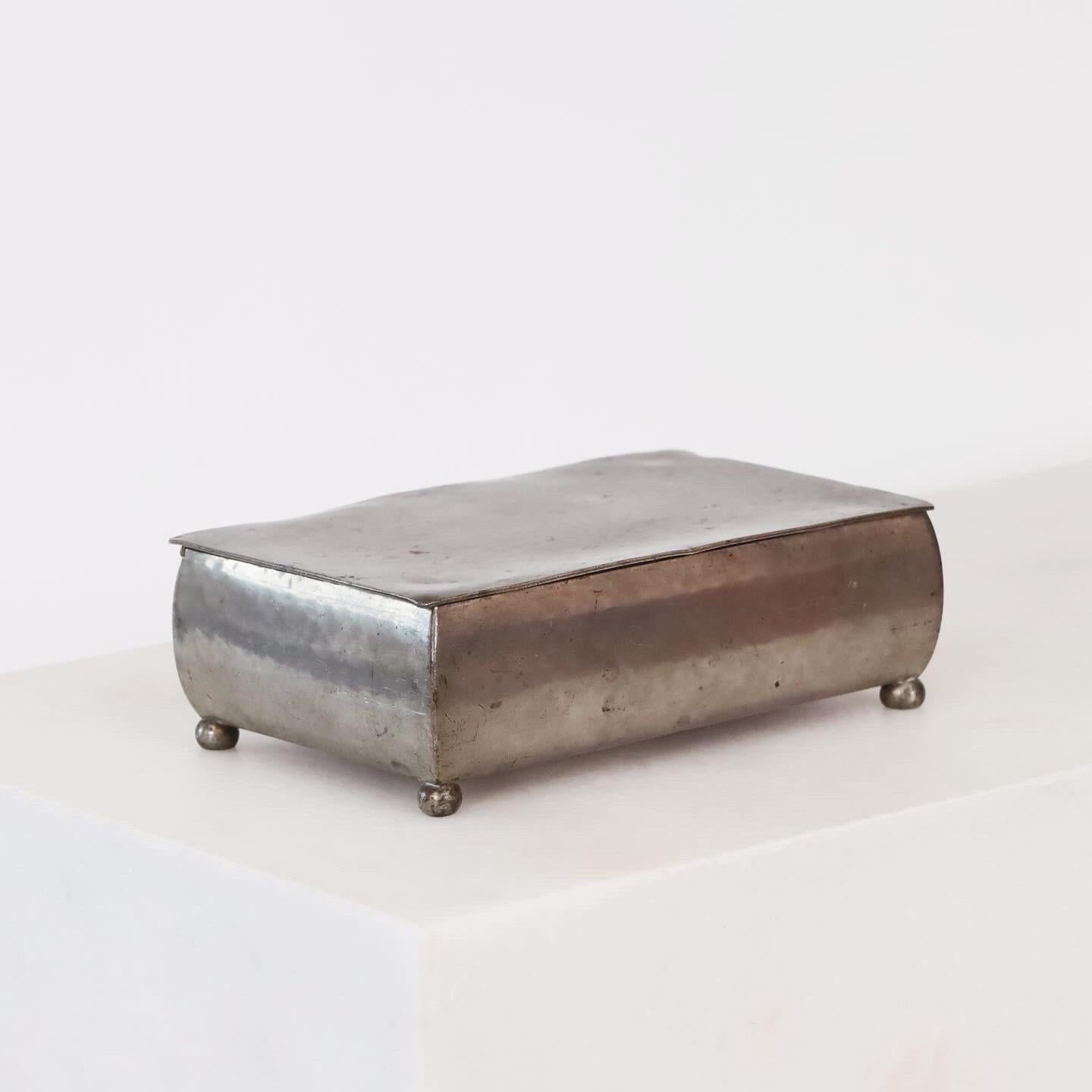 A lidded pewter box made by Just Andersen in the 1920s. A timeless piece with 100 years of stories. 

* A lidded pewter box with a wooden inner box. Originally cigarette box.
* Designer: Just Andersen
* Style: 55C
* Manufacturer: Just Andersen
*