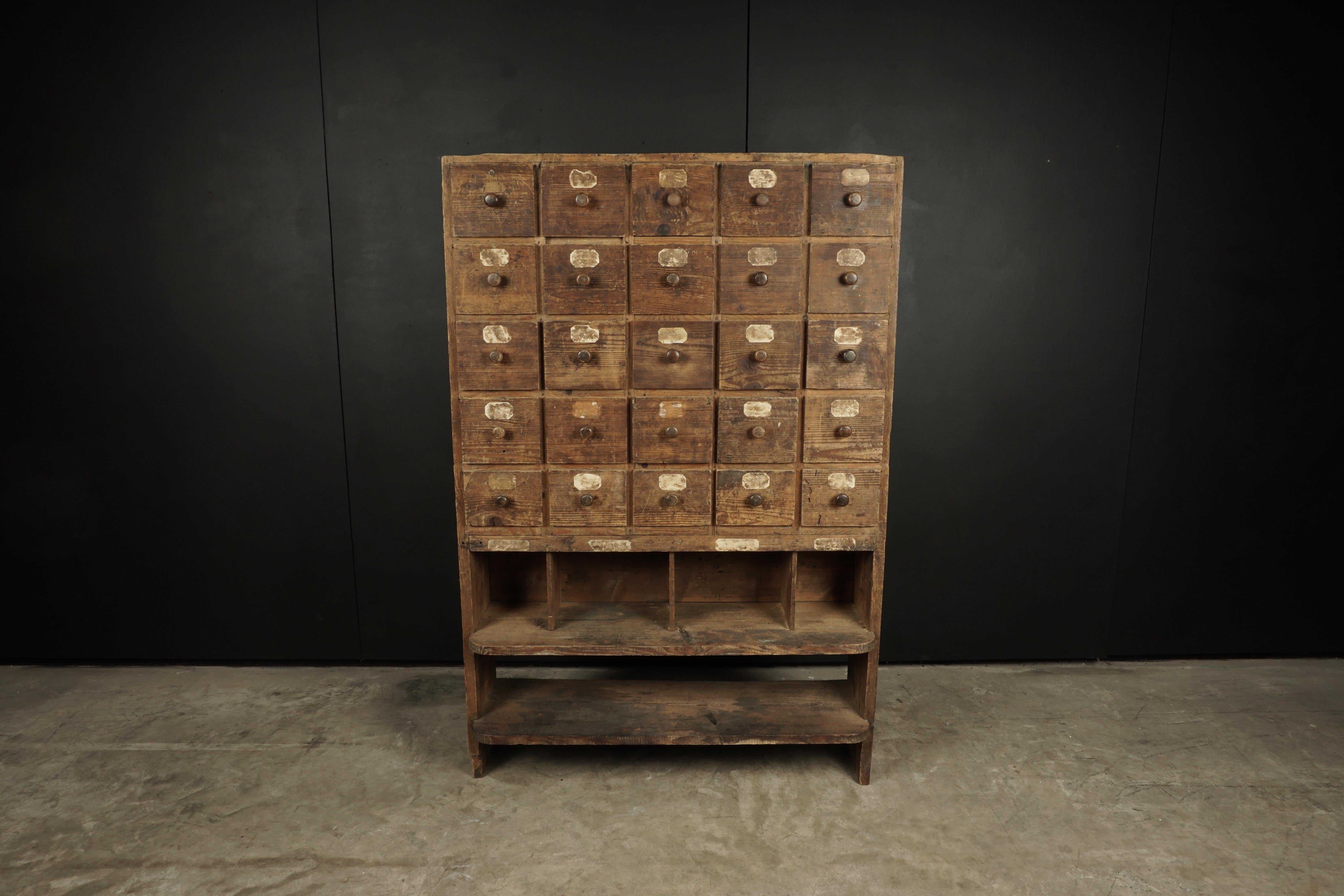 Early pine multi drawer cabinet from France, circa 1940. Fantastic patina with original labels.