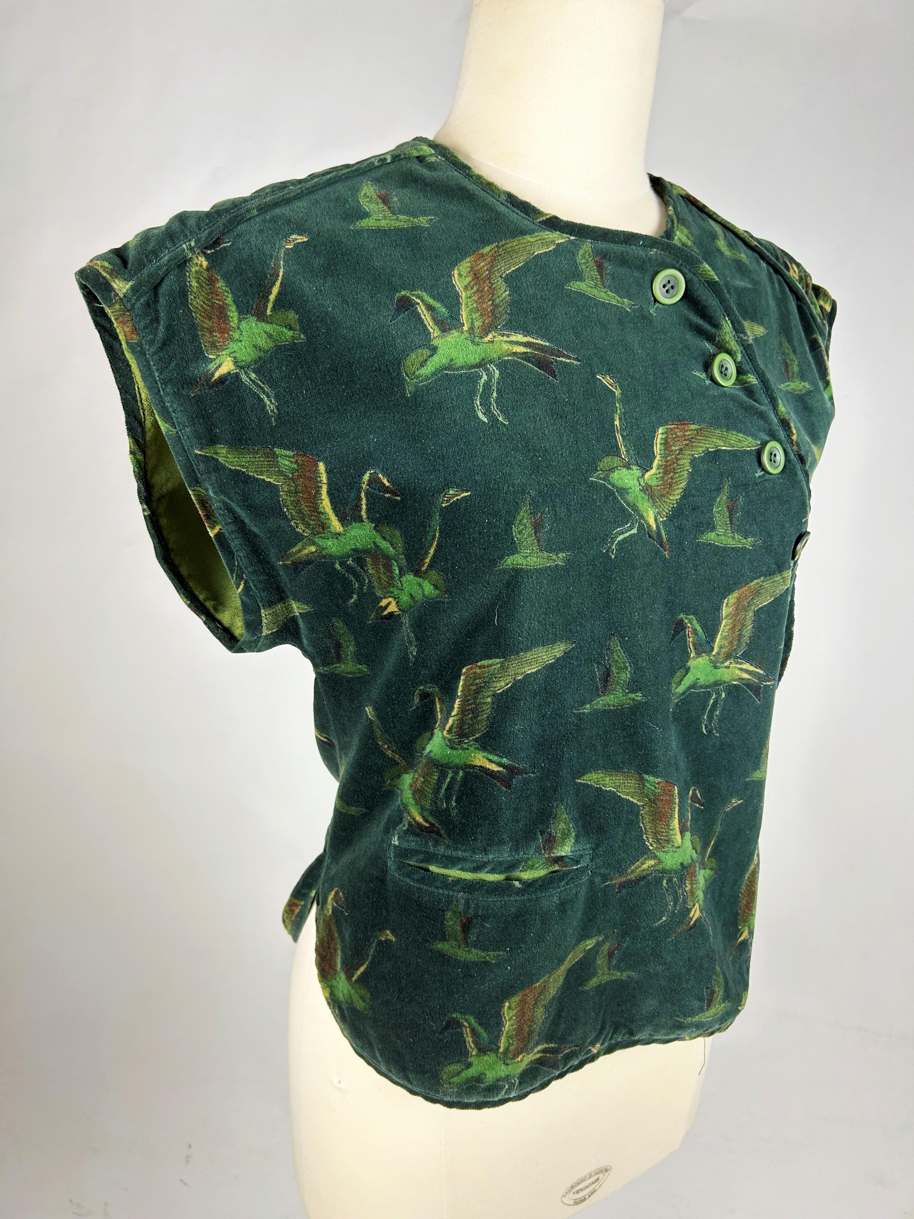 Circa 1975

France

Rare Japanese-print velvet bolero from the early days of Kenzo Takada and his first brand Kenzo Jap dating from the 1970s. Sleeveless wrap-around bolero with kimono cut-out at the shoulders, in bottle-green velvet printed with
