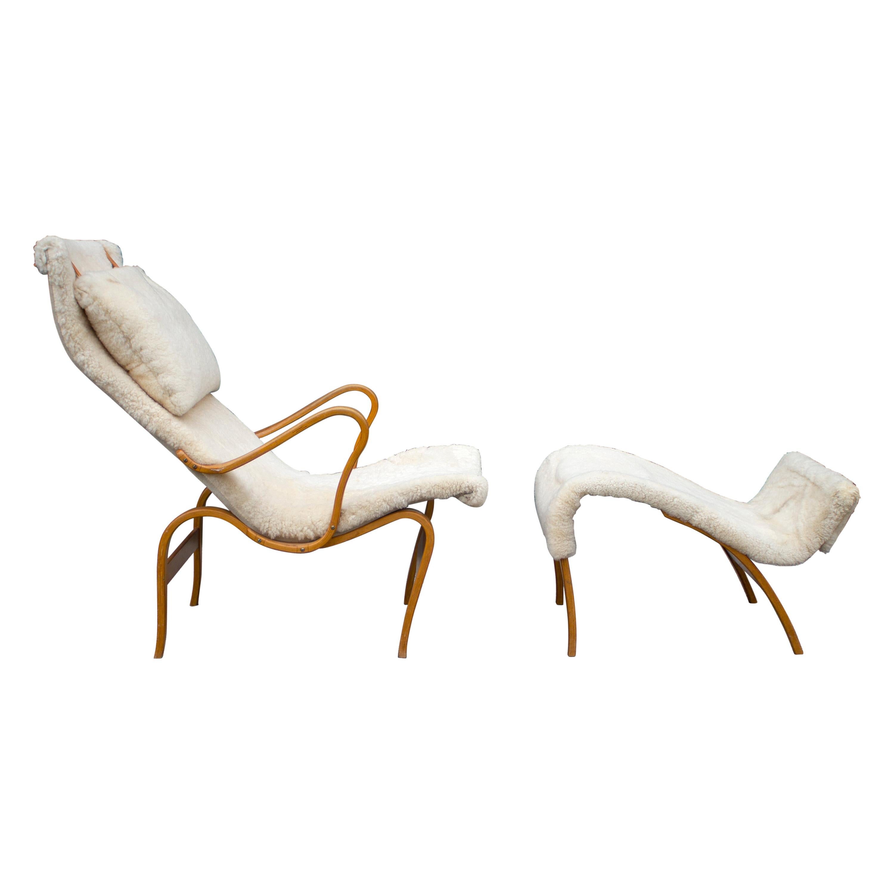 This is an exceptional example of the Bruno Mathsson Pernilla Chair covered in off white sheepskin. The ottoman nests up to the chair to create a chaise lounge. It is the more desirable, earliest production version manufactured by Karl Mathsson and