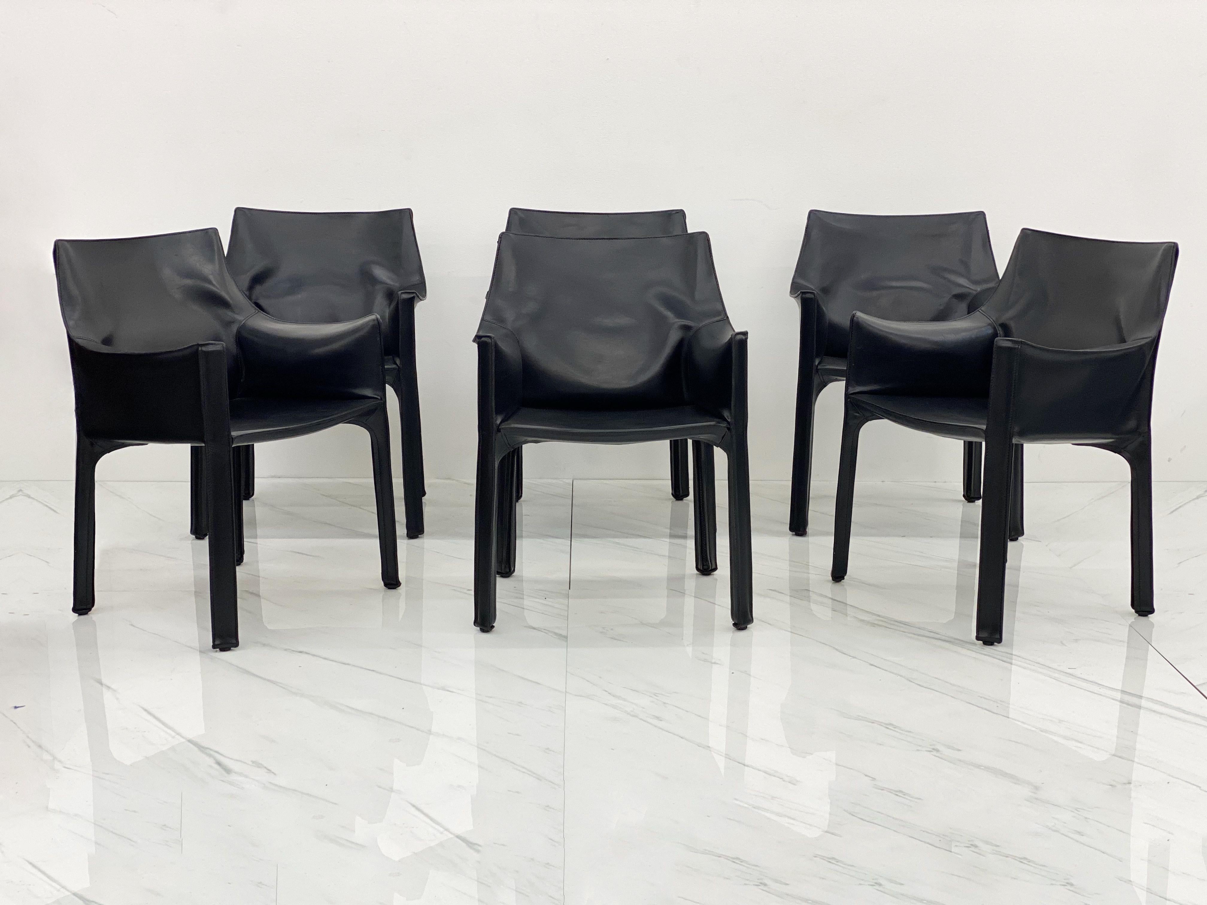 A rare set of six (6) early year 'original' production Model #413 'Cab' armchairs in gorgeous deep black leather by Mario Bellini for Cassina. Designed in 1977, this set is from Cassina's original years of production of this design, circa late 1970s