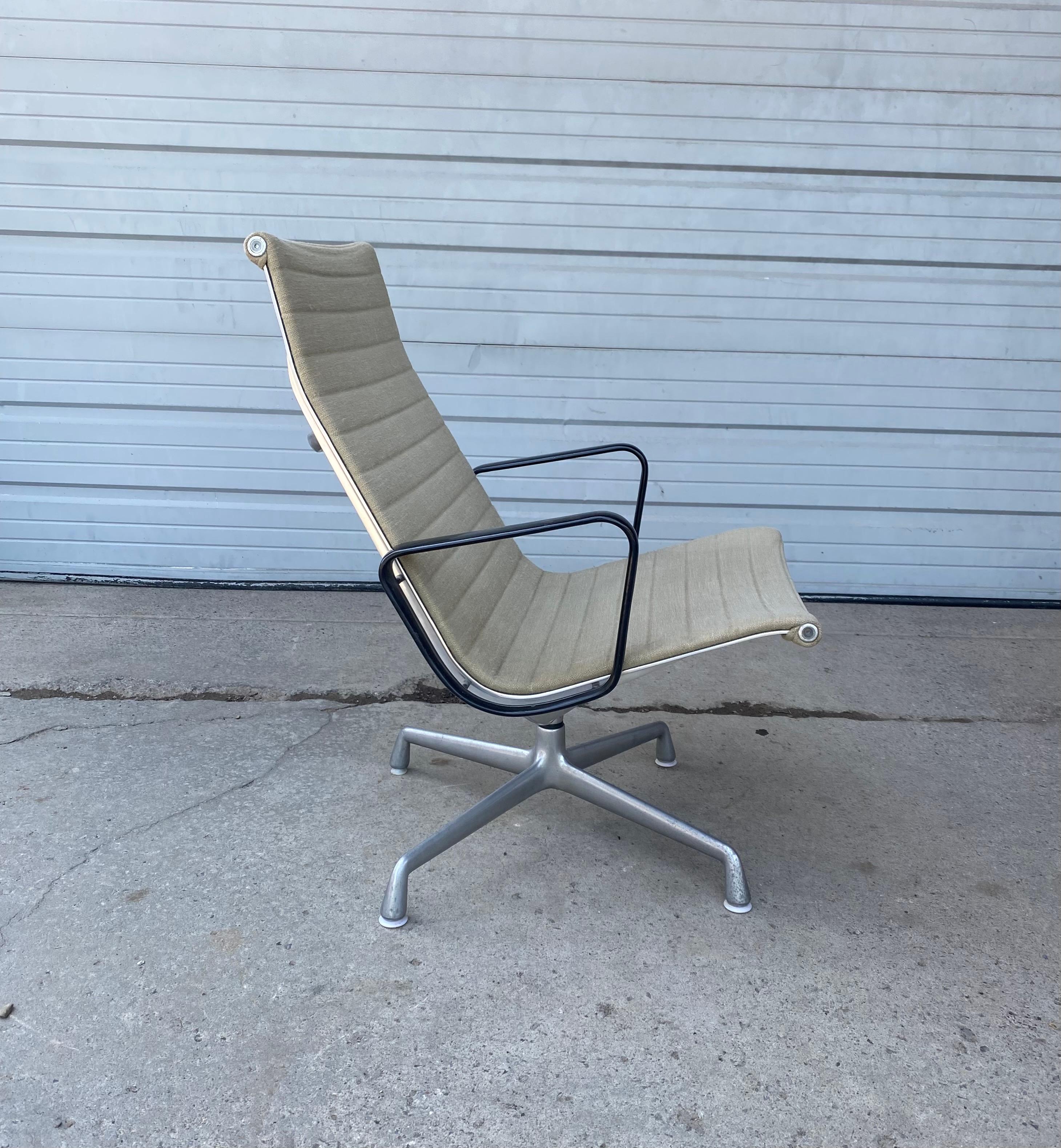 Early production Eames aluminum group lounge chair / Herman Miller,,, Four star base seldom seen black arms Retains original off white wool upholstery. Impressed Herman Miller labe. Classic Mid-Century Modernist.