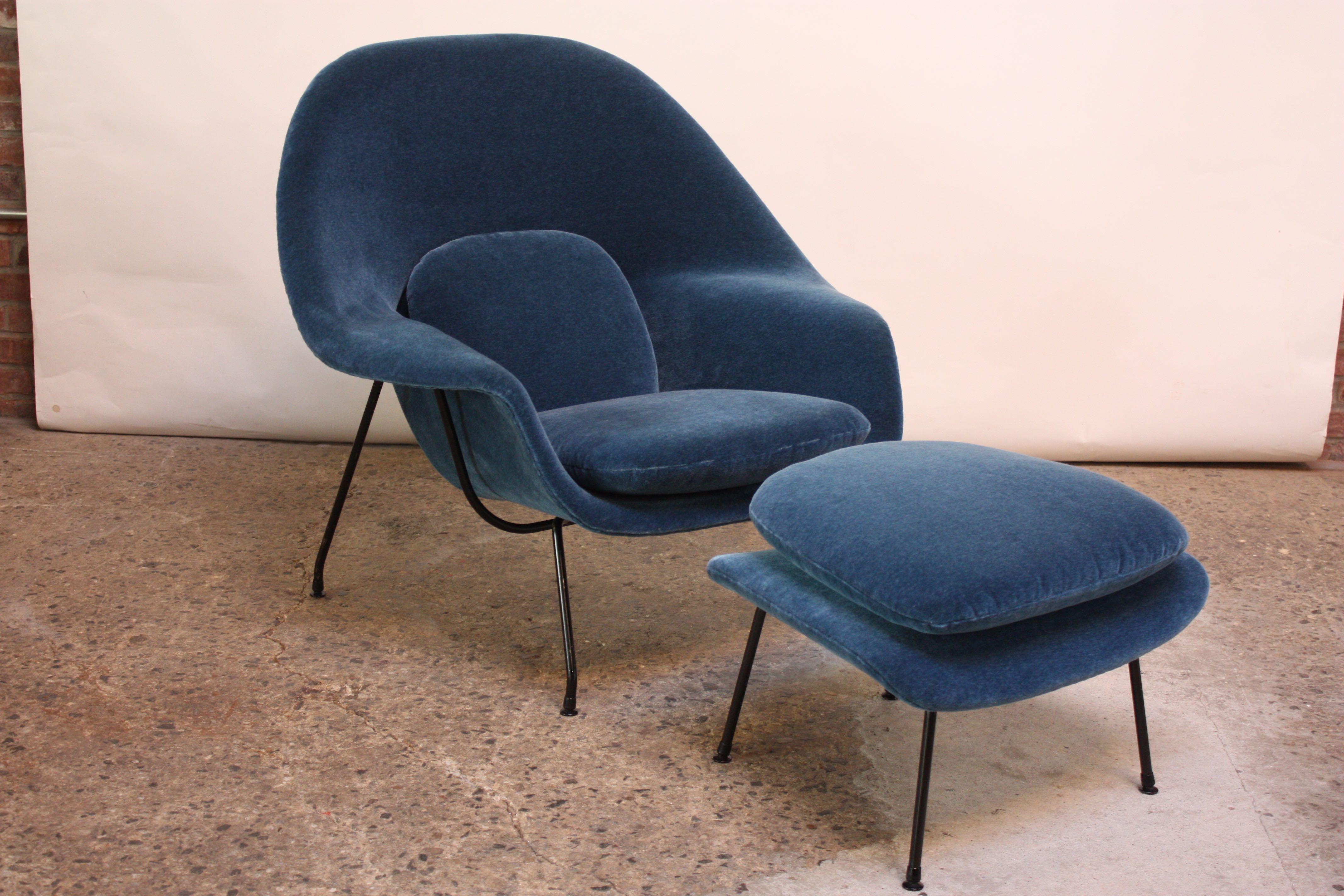Iconic, early example, circa 1950-1951 'Womb' chair by Saarinen for Knoll. Newly recovered in blue mohair. Bent-wrought iron frame retains its original black paint and press-on glides (indicative of an early production). There is paint loss to the