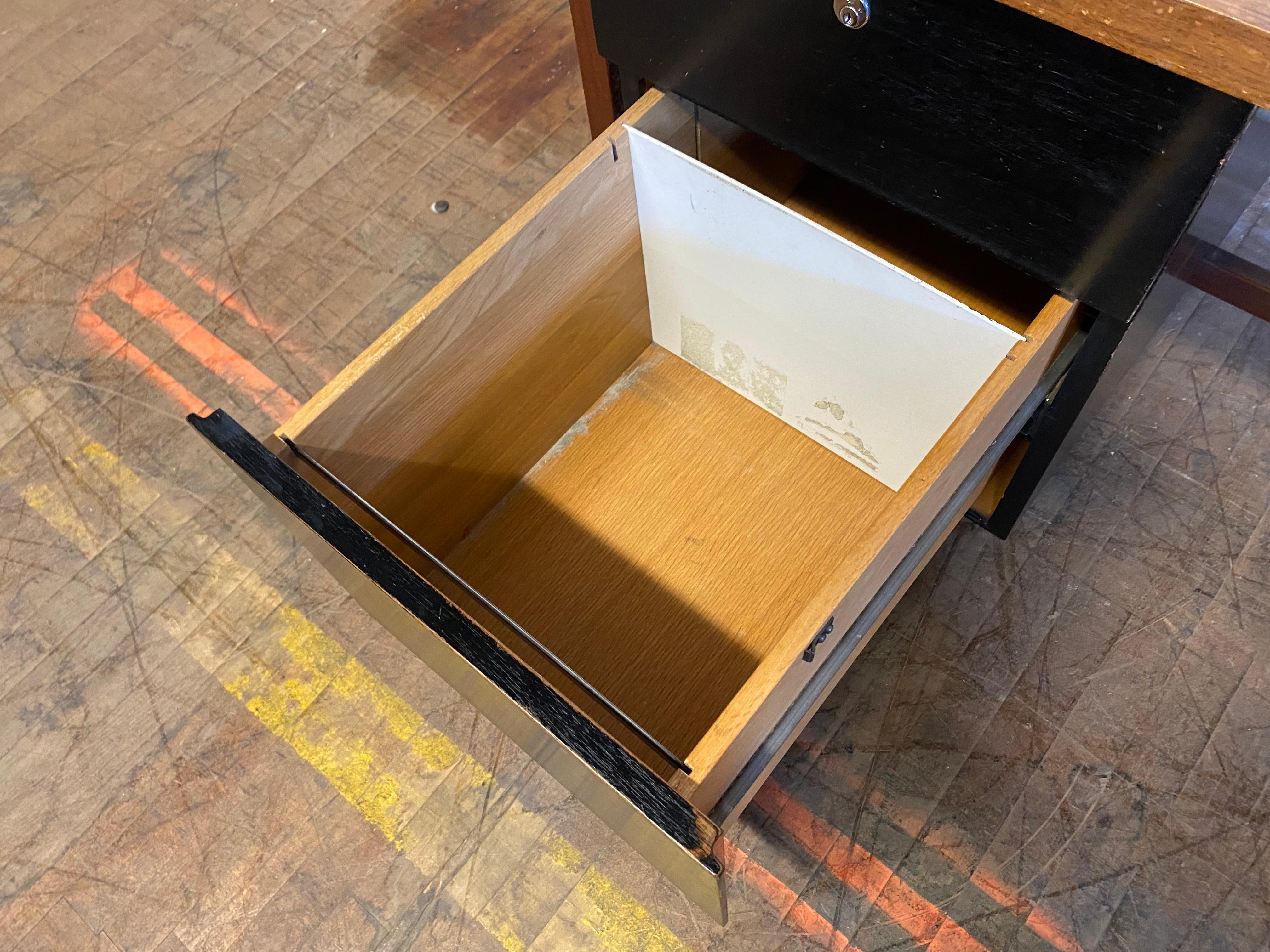 Early production walnut and rosewood desk designed by Florence Knoll for Knoll ,features richly grained walnut top rosewood frame, pencil drawer and file drawer. Retains early Knoll label. Minor blemish to rear corner (see photo) Hand delivery avail