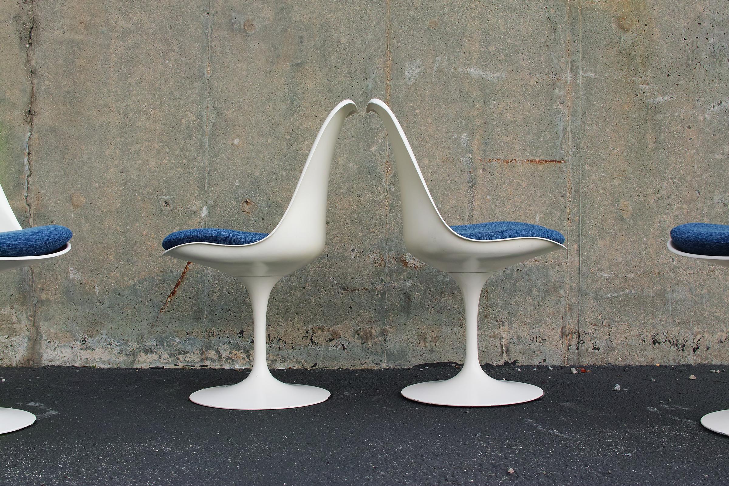 For your consideration is this authentic, very early production set of Eero Saarinen for Knoll Tulip Chairs, signed and dated 1960. The chairs feature upholstered blue wool blend seat pads, original soft white finish, lightweight yet sturdy