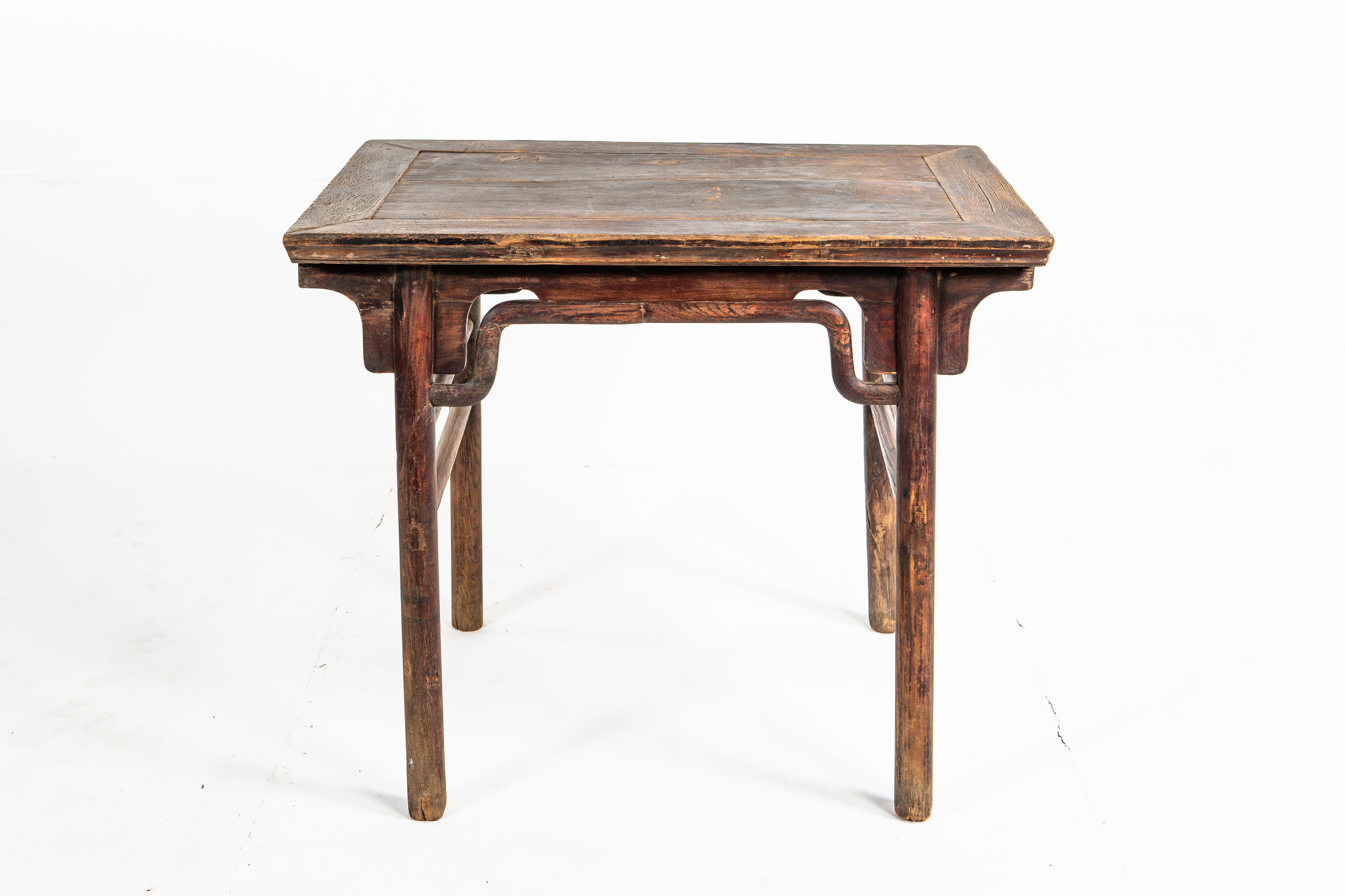 This painting table dates to the early-Qing dynasty and was made from elm wood. The rectangular table features round post legs and a beautifully aged original patina.